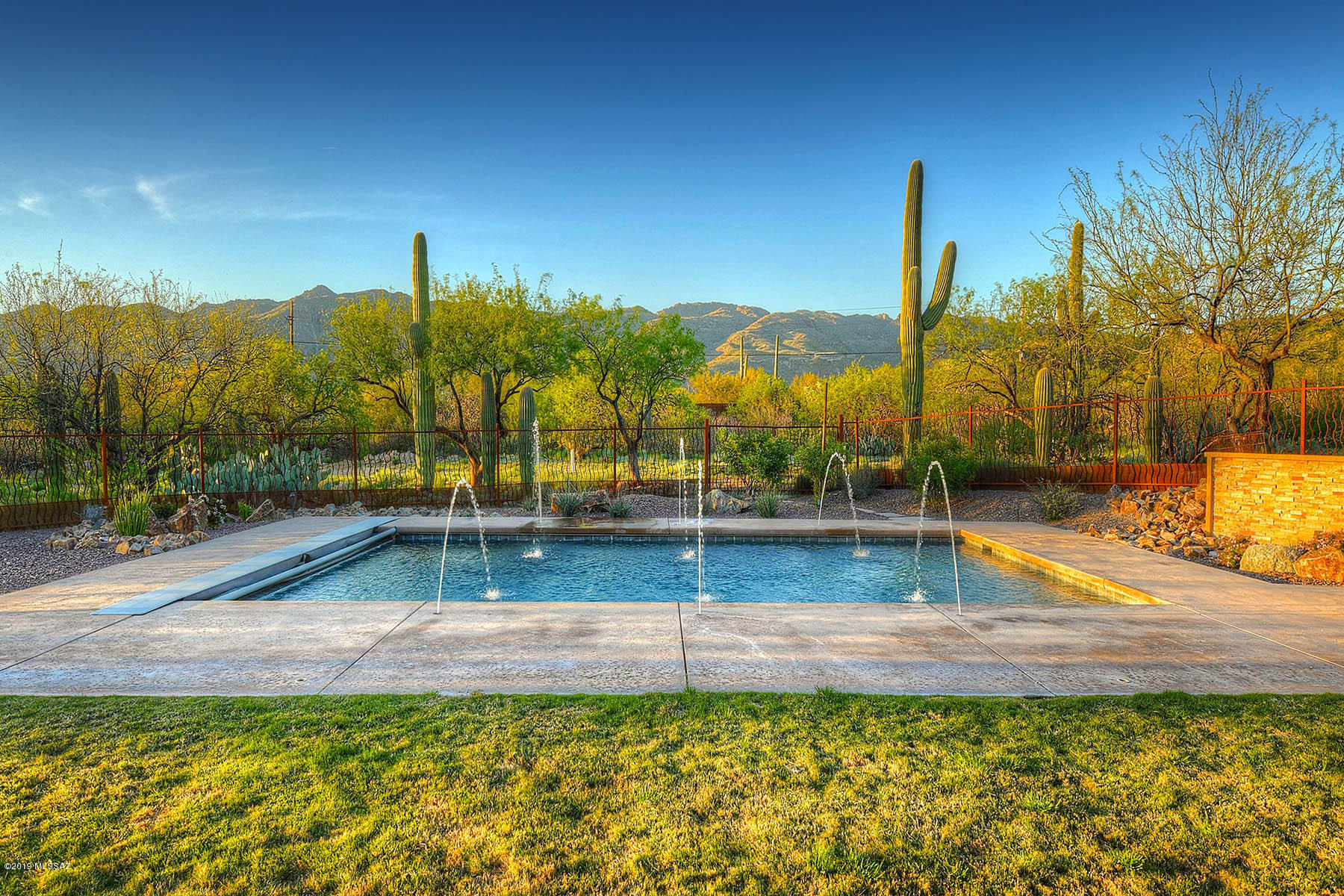 Walk inside & the first word you will say is ''WOW''! Wait until you see the Breathtaking Views. This 4183 SF, 4 BR, 3-1/2 BA + Office/5th BR Custom Home is all about Enjoying the Mountain Views. Gourmet Chef's Kitchen Features Natural Cherrywood Cabinetry, Commercial-Style Refrigerator/Freezer, Gas Range & Hood + Double Oven. Guests will Congregate Around the Granite Island Focal Point. Finishes include Tumbled Travertine Tile Floors & Alder Doors. Large Master Ensuite is Sure to Please. Split Bedroom Plan & Bedrooms have attached Bathrooms. Oversized 3-Car GAR w/Epoxy Floors & Secure Storage Rm. Perimeter Fencing w/Enclosed Backyard around Heated Pool w/Electronic Pool Cover, Covered Patios, Entertainment Area, Fireplace & Water Feature. 4.29 Acre Horse Property w/Shared Well & No HOA.