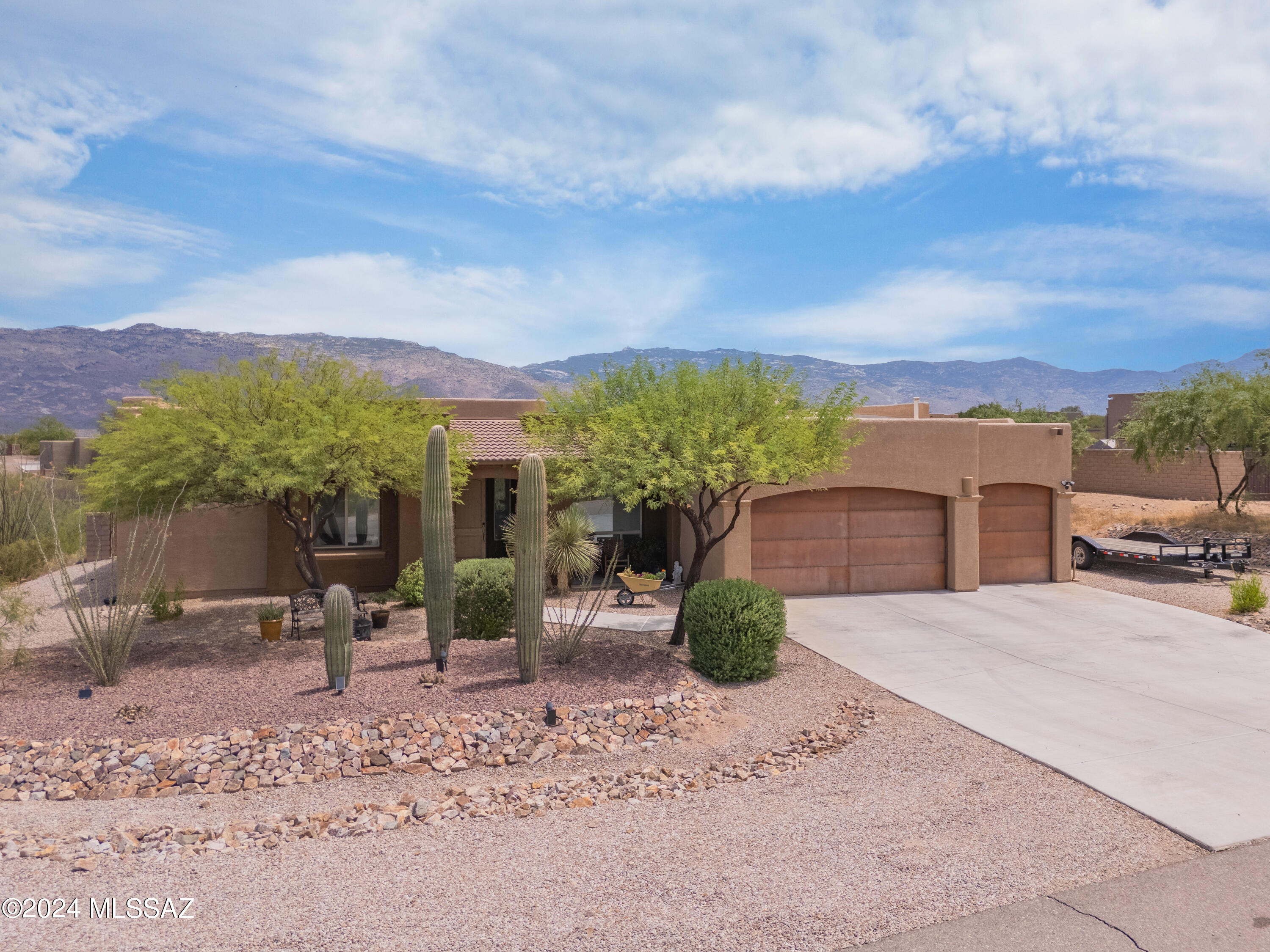 Welcome home! Amazing 4BR/2.5BA home with a backyard oasis, outdoor kitchen, sparkling salt water pool, and Rincon Mountain views. This home sits on .84 of an acre with rolling hills topography, a thick desert wash area that runs at the back of the property and space between neighbors to enjoy the north facing backyard patio. Large kitchen with two islands, great room with adjacent dining room for entertaining, split bedroom plan, and complete with very nice finishes.  Large Owner's Suite bedroom, bath and custom walk in closet.  North/South facing and backyard looks right at the Rincon Mountains.  Quiet cul-de-sac street.