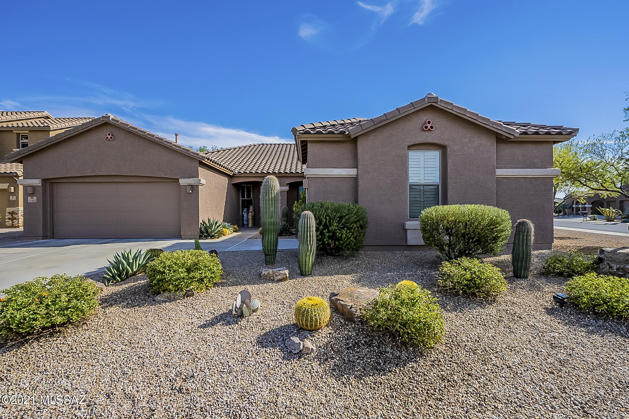 Exquisitely upgraded home with mountain views in gated Tangerine Crossings.   Upon entering, you will notice the many premier touches in this 3 Bedroom plus Den home. Open Concept living featuring vaulted ceilings, tile flooring, surround sound, and fireplace. You will never want to leave the Gourmet Kitchen with double ovens, gas cooktop, wine cooler, expanded cabinets, granite countertops, walk-in pantry and large island.  The Primary Bedroom with Bay Window and the en-suite bathroom has an expansive custom shower, dual vanities and accesses the walk-in-closet. Entertain in the Backyard with full length covered patio, pool with solar heating, upgraded landscaping & lighting, and built-in BBQ. The 3-car garage has storage & backyard access. This is the home you have been waiting for.