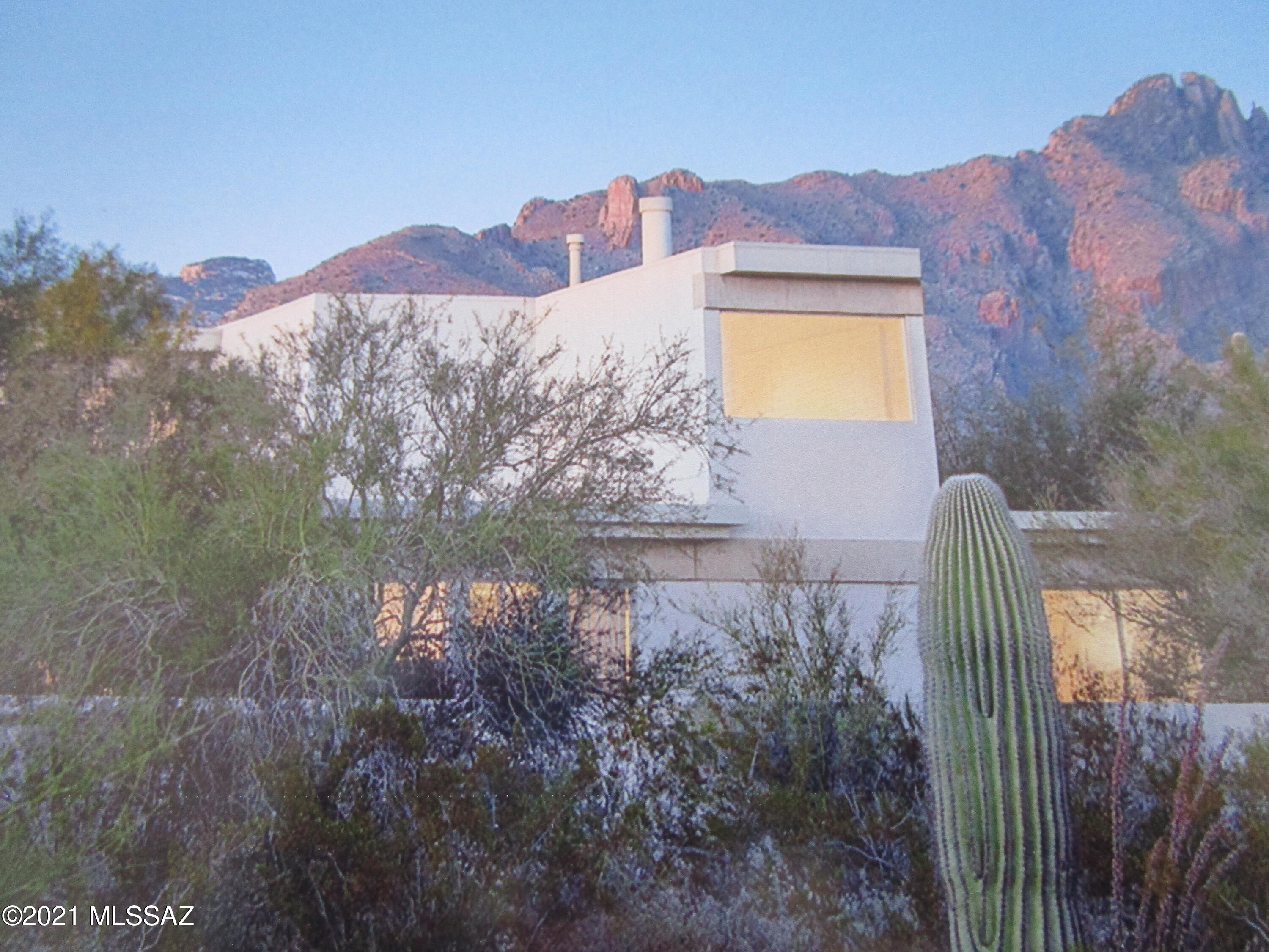 Stunning bold contemporary ''Classic'' Judith Chaffee home. Focal point library stairs is a huge conversation piece.  Studio/ has super high ceilings.   Loft located at top of library stairs. Intention is for preservation & conservation. Everything original, Architecturally significant.  Award  in Architectural Record 1979.  Mid century modern to the extreme.  Poured color concrete floors, Huge concrete beams made on property, which support abundant windows, which are fashioned to promote coolness in summer and warmth in the winter. Adjacent contiguous lot is included in this sale 108-15-120D.  Unobstructed views of city night lights, and daytime views of the Catalinas.  May qualify for both Pima County Historic Landmark designation as well as National Register of Historic Pr servation. 3 private courtyards
Solar array along southern edge of property.  used collectors for heating the swimming pool  5,000 ga. capacity tank under entry courtyard was part of the original system not working as is.  Please note, 3rd bedroom is also the Den/Studio.  Closet in room.  Your choice as to what you will use it for