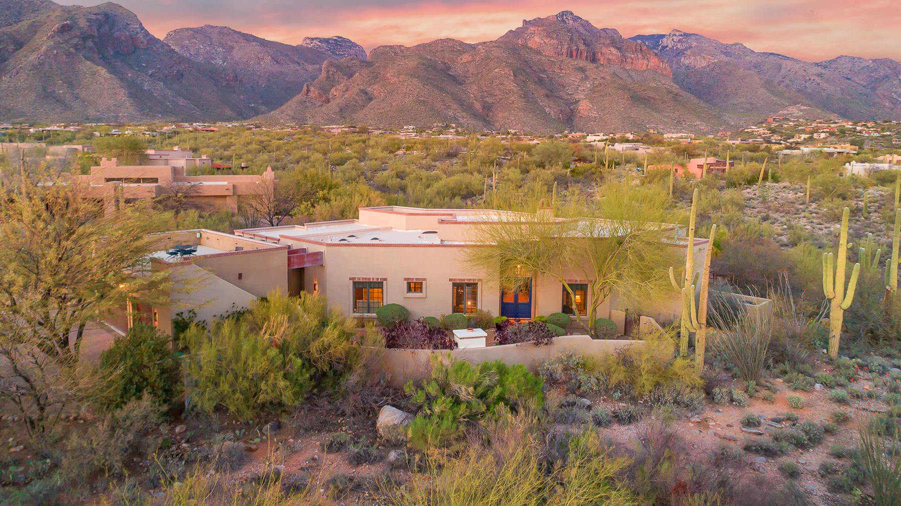 Enjoy privacy and unobstructed mountain views from this soft SW contemporary within the prestigious gated community of Pima Canyon Estates. Entering through gated courtyard w/ fireplace, this open and airy 3,285 sq. ft. home welcomes you into a spacious & livable floor plan showcasing polished concrete floors, oversized alder doors throughout, & built-in architectural elements. This split 4-bed/3-bath plan features additional office AND den/media room. The gourmet kitchen, which satisfies the most discerning chef, features quartz & granite counters, SS appliances, and flows perfectly into great room flooded with natural light. Perfect for entertaining, this home features resort-like back yard w/ pool/spa and immense rooftop observation deck taking advantage of panoramic city/mtn views.