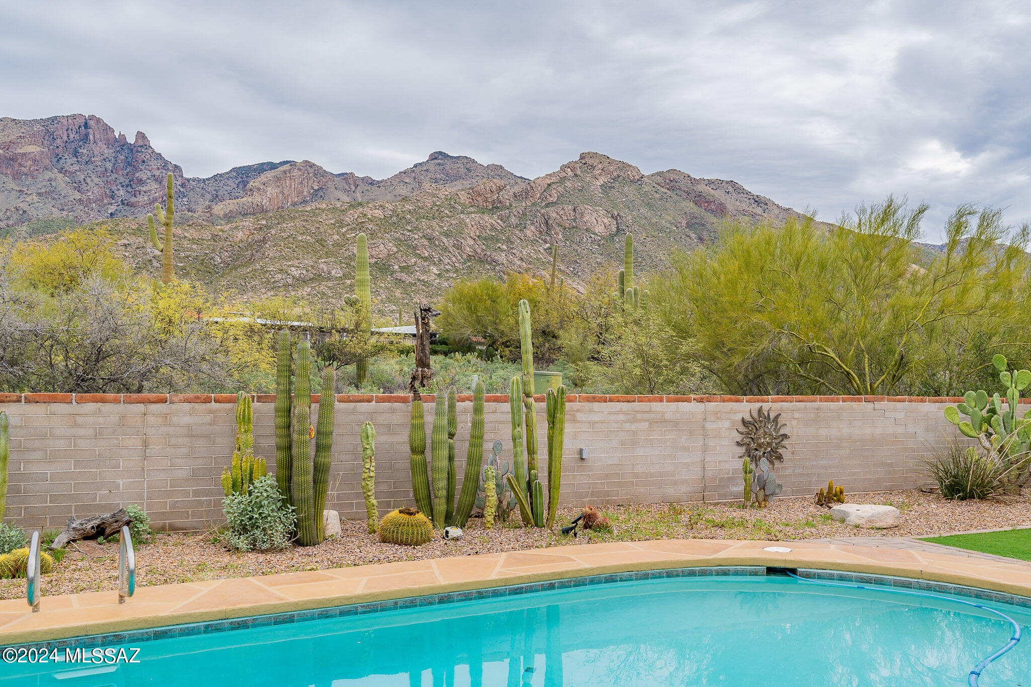 Nestled in the heart of the Catalina Foothills within the highly sought-after Coronado Foothills Estates, this enchanting Classic Burnt Adobe territorial home embodies the essence of Tucson lifestyle. Situated on nearly an acre of desert landscape, every corner of this 4 bedroom, 2 bathroom home is suffused with natural light and boasts breathtaking panoramic views of iconic Finger Rock, Catalinas, Rincons, and the twinkling city lights. Kitchen adorned with Talavera tile, seamlessly flows into the family room, offering effortless access to the covered back patio with and the sparkling pool, fully fenced backyard with breathtaking mountain views. The large artist's studio boundless opportunities for creative endeavors. With a flat driveway and guest parking spaces, welcoming friends and family is effortless. Conveniently located within the esteemed Catalina Foothills school district, and with easy access to Finger Rock Trail, La Encantada, and La Paloma Country Club, mall, fine dining and much more... this home offers the perfect blend of serenity and convenience. Whether it's the allure of the natural desert landscape, the proximity to essential amenities, or the vibrant Catalina Foothills real estate market, this home isn't just a place to liveit's a lifestyle to embrace. Don't miss your chance to make it yours.