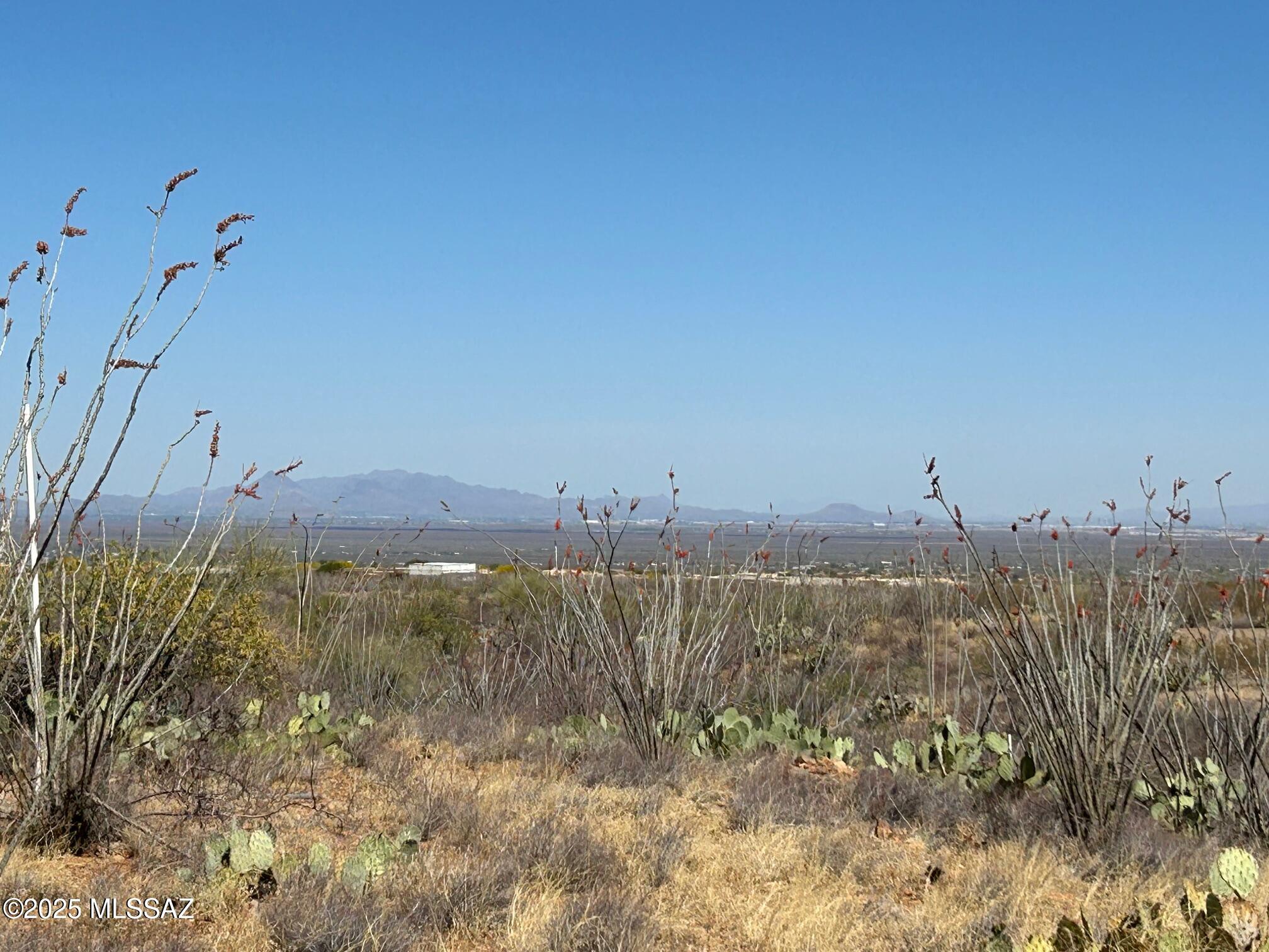 END of CUL DE SAC BEAUTY. SWEEPING, DRAMATIC, PANORAMIC VIEWS of the ENTIRE TUCSON BASIN from this level building pad filled with LUSH VEGETATION. Enjoy these 160 degree views of City Lights and the BEAUTIFUL SANTA RITA MTNS. Follow the pink flagging from the street over a small wash and back up to the pad. All lots are 4.17 acres providing for great home separation and lots of natural open space surrounding homes. Underground water, electric, gas, phone and cable along with paved access add to the allure of this FOOTHILLS SUBDIVISION at the base of the Santa Ritas, This is one of the DEVELOER'S last 5 lots just put on the market; all priced between $149,000-$164,000. Build among Million $ plus homes. See attached documents for useful information. Call to meet LA on site and walk them all