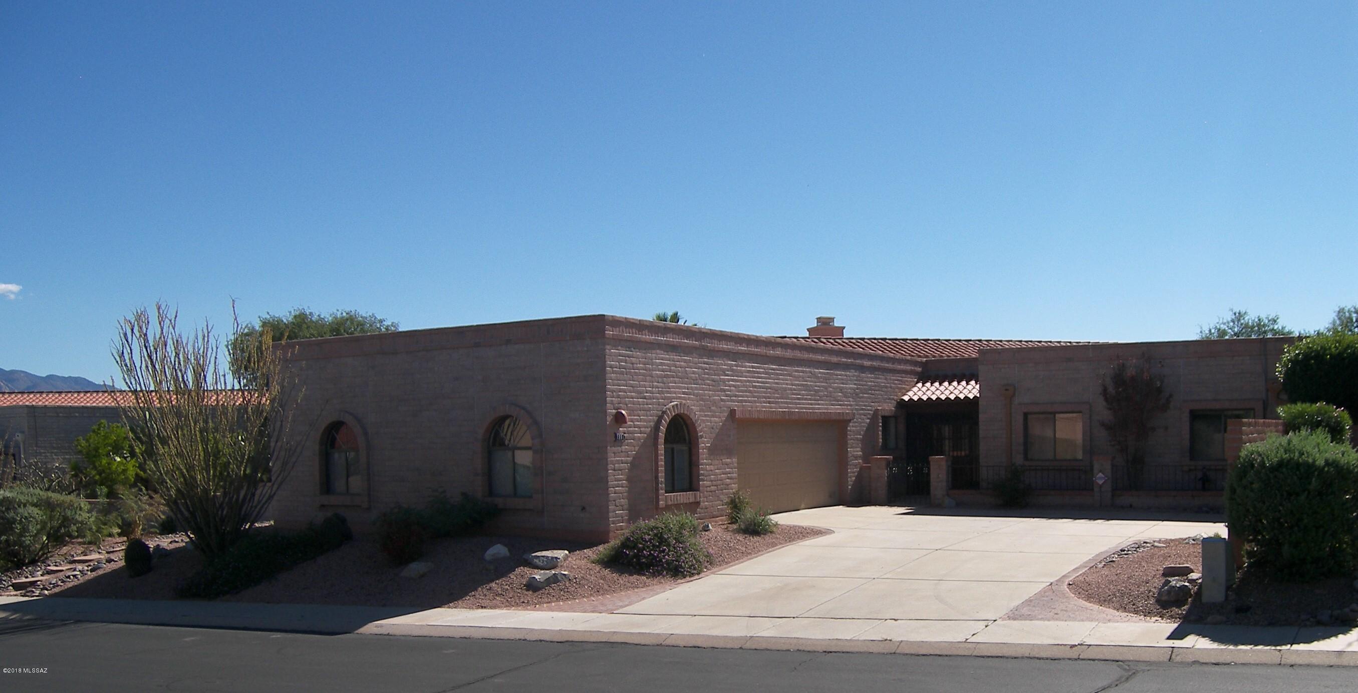 This home is a must see for those wanting wonderfully spacious rooms, high ceilings, exposed beams, fireplace, tons of storage and separate quarters for guests. Can't say enough about the privacy and amazing Santa Rita mountain views. The golf course peeks out behind a lush desert buffer. New quartz kitchen counters, freshly painted interior, ceramic tile in kitchen & guest bedroom. This popular Granada model is expanded offering an AZ room off the kitchen & a casita affording room for your guests and/or your hobby, exercise or art studio. Rooms include 2BR, 3BA, extended length den, great room with dining area, large eat-in kitchen with pantry and walk out to heated AZ room. Other side of the apprx 24Dx25.5W garage is casita/bonus rm w/full bath.  Casita is not included in the sq footage.