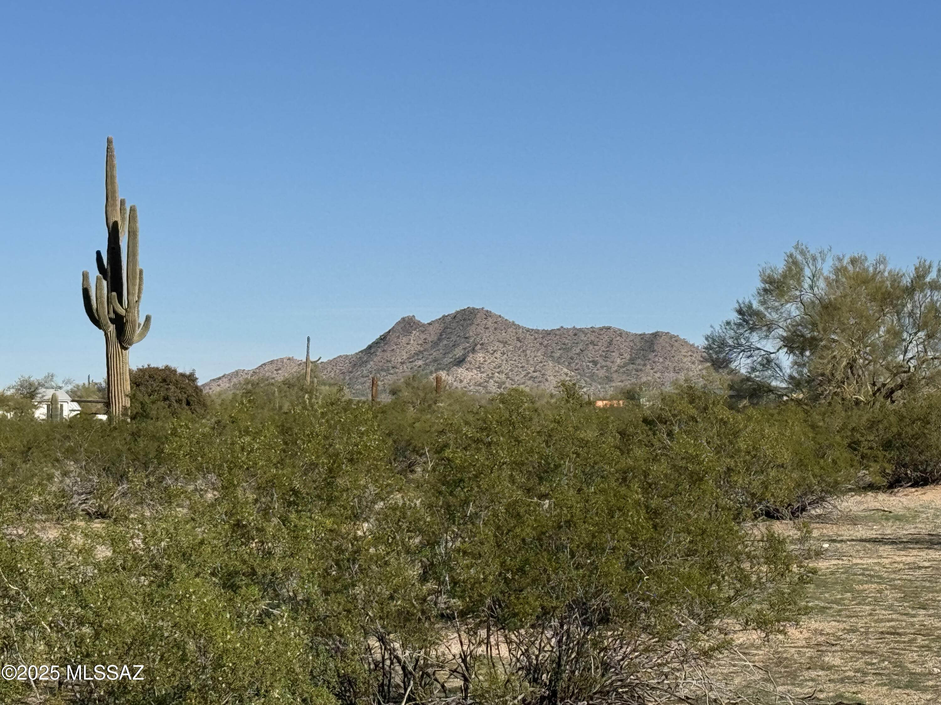 Large usable 5 acre parcel with shared well, electric and phone. Corner lot with Saguaros, mountain views, and unbelievable sunsets. Step off your lot an ride your horses or ATV to the mountains for a private picnic. So many trails to explore. Easy access to I-10. Country living at your finger tips. Water and electric on SE corner near fence line.