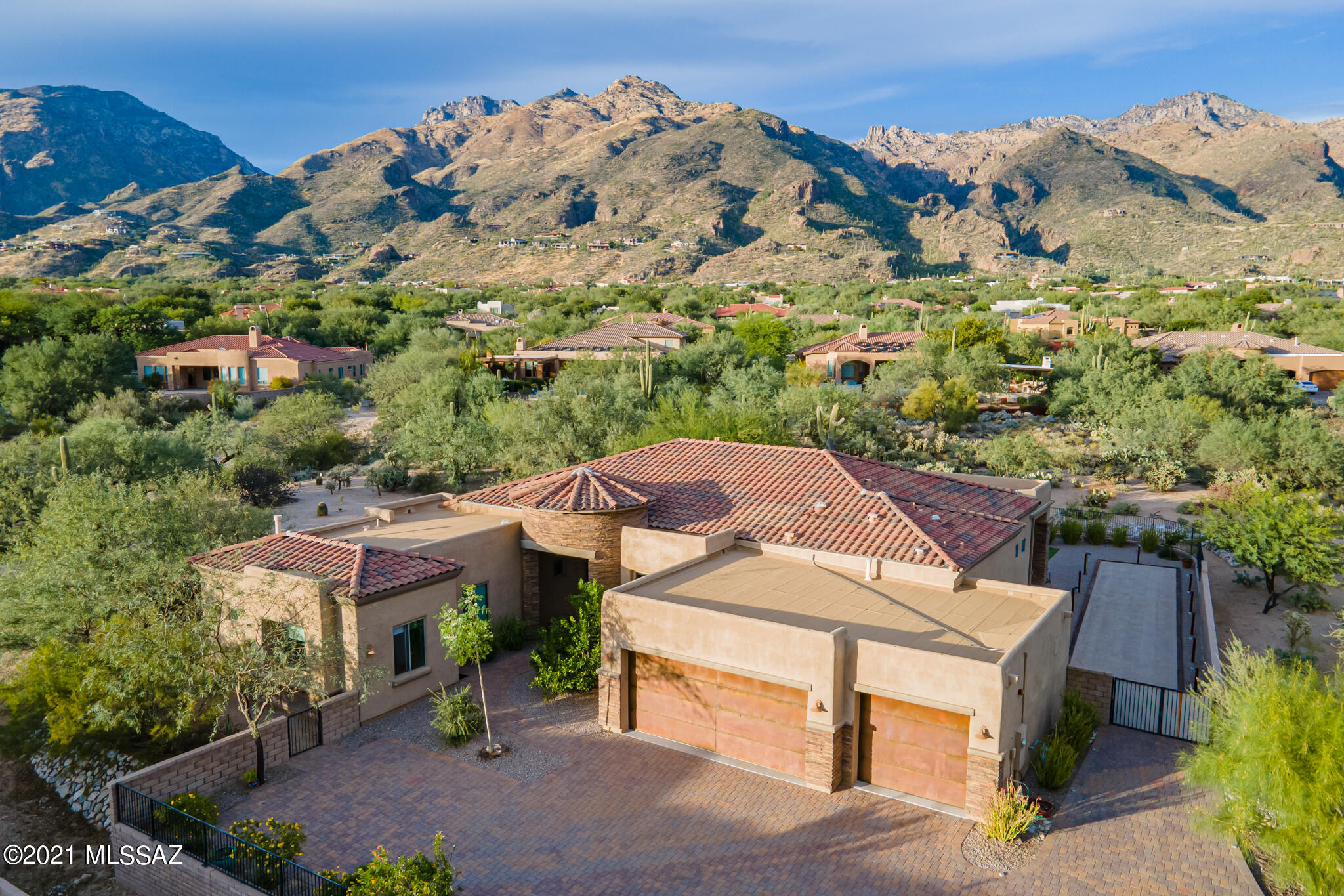 Spectacularly designed contemporary home in secluded gated Ventana Reserve. This treasure features 4BR/5BA with Den. Separate guest quarters with outside entrance. Main house is 3630 sq feet and 4th BR/guest quarters is 294 sq ft. Stunning island kitchen w Euro style cabinetry, quartz countertops, SS appliances incl. Thermador gas cooktop.Exquisite finishes have been carefully chosen throughout the home, designer tile work, stunning light fixtures and beautiful polished concrete floors. Enter into the open living room w white wavy wall panel featuring a floating fireplace. Expansive sliding glass wall frames the Catalina Mountains. Stunning master bedroom suite w 2 walk in closets. Guest bedrooms feature en suite baths. Beautiful private backyard retreat with fireplace/waterfall, hot tub and bocce ball court. This home has been meticulously maintained and offers abundant privacy on this beautiful .9 acre lot.  A true Tucson jewel.