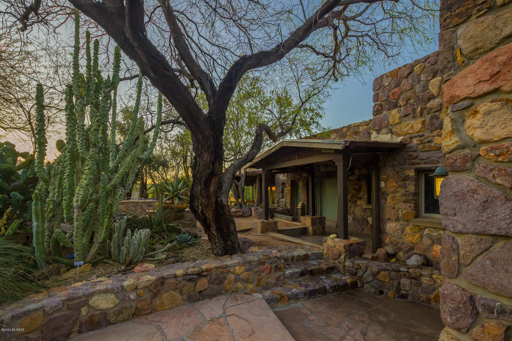 If you want VIEWS, privacy and lush desert landscaping close to town,  keep reading!  One of a kind, Historic Riddle Ranch, Homesteaded in 1928.  History abounds this Iconic rock house on 8+  in the beautiful Tucson Mountains.  Minutes from Downtown Tucson, St. Mary's and U of A.   Riddle Ranch  has been lovingly updated in 1995 and expanded over the years., a 4,930 sq ft  main house and 1,258 sq ft of  detached guest quarters, you'll be charmed at every corner.  Rooftop viewing deck, negative edge pool, game room, exercise room, art studio.  NO  CC&R's and zoned for an additional land split.  Wow!  Maybe a Bed and Breakfast, Horse Ranch, family compound or rent the guest facilities.  visit www.riddleranch.info   tax parcel # will be modified with new survey. Taxes will decrease.