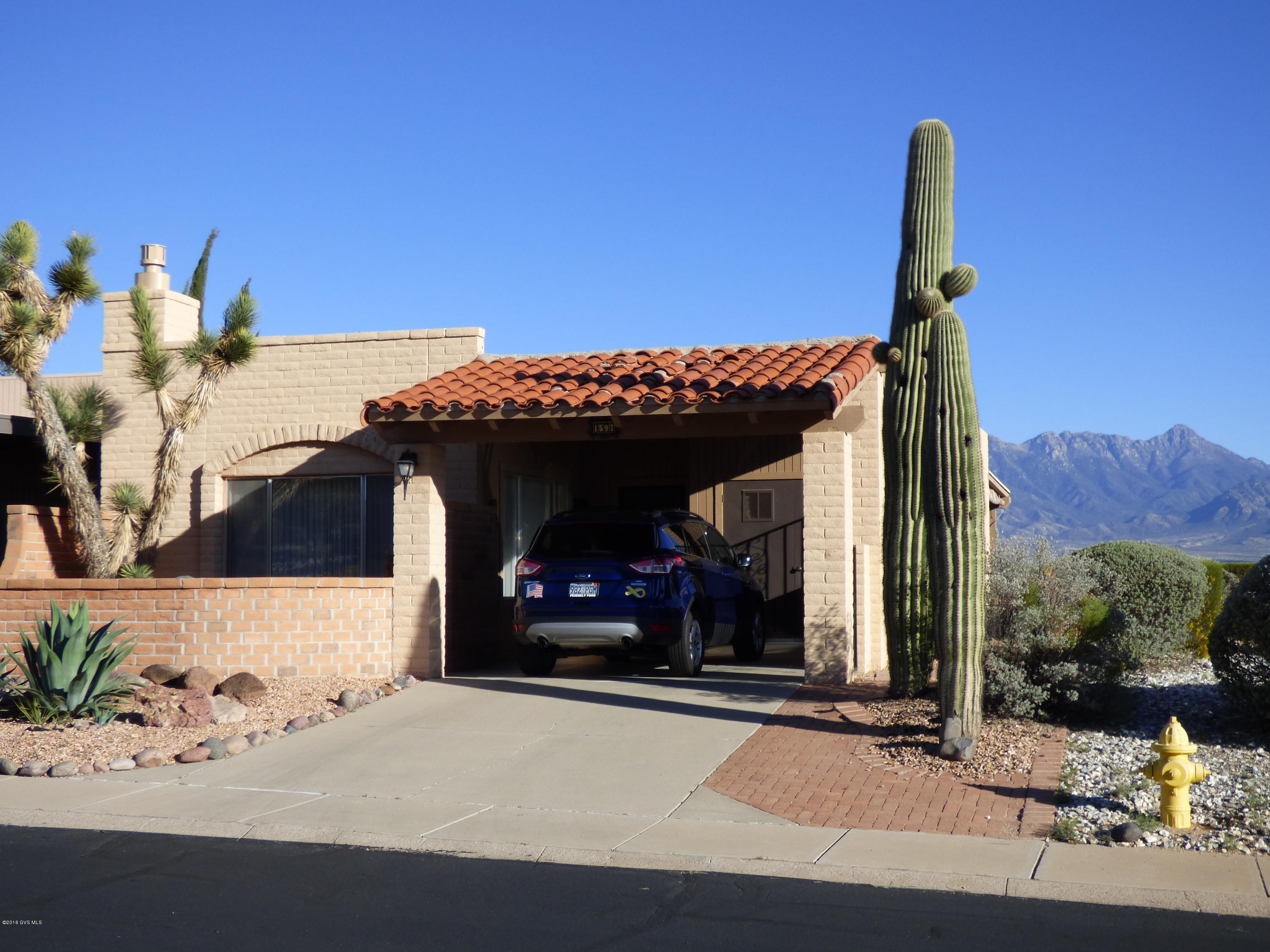 Exceptionally well maintained view home on great corner lot with large patio and easy care yard. Cozy beehive fireplace with new remote controlled gas log insert to warm the living room. New quartz counters in the kitchen, newer appliances. Separate dining area with wet bar. Day area/den on the gorgeous view side can be second bedroom by adding a short wall and door. Large master bedroom and bath. Wide open mountain and valley views from the covered patio. Large fountain ads to ambiance. 2 yr old heat pump, new gutters and home has been repainted. Front court yard has new pavers. Storage off carport is large enough for a golf cart. Must see this special home. Most furniture and other items available by SBOS only.