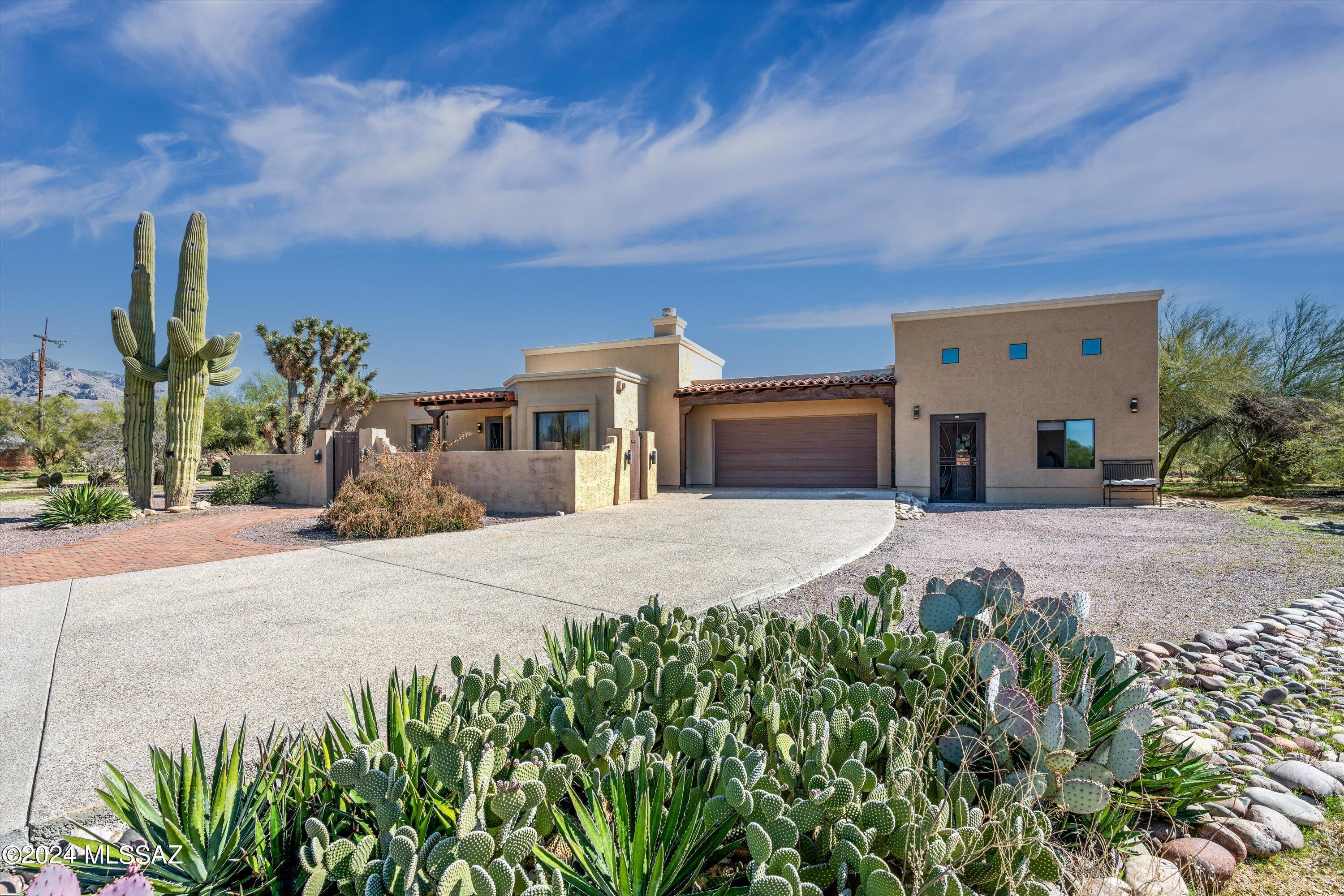 Immerse yourself in tranquility at this 5-bedroom desert oasis nestled on a scenic 1.21-acre lot in sought-after Casas Adobes Estates. Unwind in your resort-like backyard, where breathtaking Santa Catalina Mountain views beckon you to relax by the waterfall pond, soak in the spa, or swim in the year-round solar-heated pool.
Picture yourself hosting unforgettable gatherings with loved ones in this entertainer's haven. Imagine laughter echoing through the spacious backyard, creating lasting memories. Your guests will enjoy privacy and convenience in the bonus 820 sq. ft. guest house, complete with a private entrance, full kitchen, walk-in shower, 2 bedrooms, a loft, and ample storage - perfect for multigenerational living or welcoming guests. Step inside to a beautiful open floor plan that offers warm natural light. Soaring 12+ ft. ceilings adorned with exposed wood beams and rich acacia wood floors create a sense of grandeur. This move-in-ready residence offers endless possibilities for crafting your dream desert lifestyle.
Enjoy the best of both worlds: bask in the peace of your private oasis while having essential shopping, restaurants, and grocery stores just minutes away.