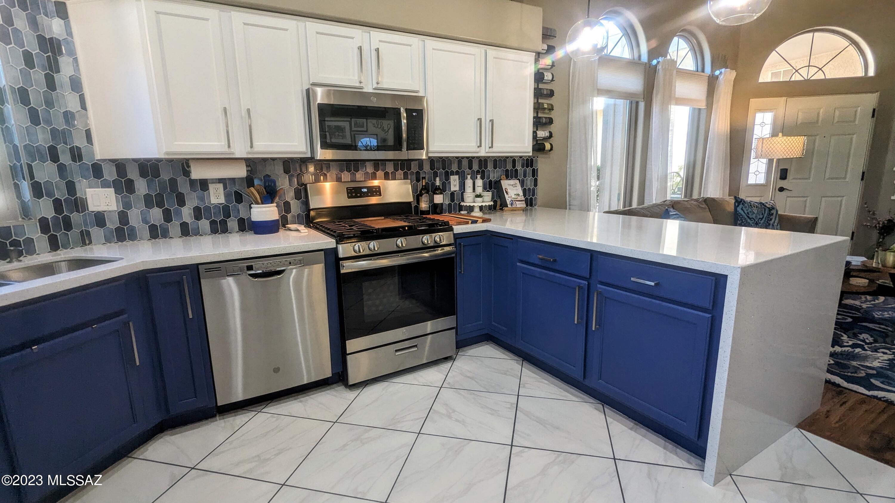 COME SEE THIS Totally RENOVATED and UPDATED! Stunning Townhome in Mona Lisa Village- an Adult Community conveniently tucked away near Tucson National. You will be charmed with the Exquisite Detailing that has gone into making this one of the very Best Townhomes to come to market: Custom Kitchen! Colorful Backsplash, Bright White Quartz Counter tops with a Waterfall Edge over Two-Tone Cabinetry, New Stainless Appliances include a GAS Oven/Range. New Diagonal Ceramic Flooring, Remodeled Bathrooms with New Vanities and Delightful Custom Tile flooring. HIGH Cove Ceilings, New Light Fixtures, Fresh FULL INTERIOR Paint, and so much more! This home is Spotlessly CLEAN and MOVE-IN READY- Don't miss this Beauty!