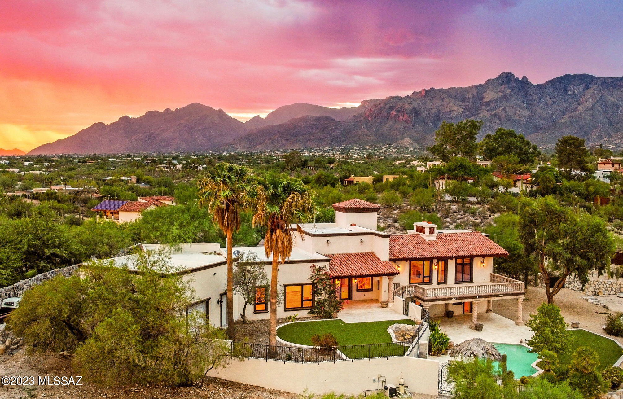 One of a kind estate nestled in the heart of the prestigious Catalina Foothills Estates neighborhood, this 5,039 sq ft, 5 bedroom, 4.5-bathroom home boasts some of the best unobstructed city and mountain views you will find. This Spanish Colonial masterpiece is a testament to high-end design and elegantly combines the best of timeless architecture with modern luxuries. 

Set on a sprawling 1.65 acre lot, which is entirely fenced in, this property offers both city water and a private well, providing the rare opportunity to create a lush oasis in the desert. The estate is also a horse-friendly property, with no HOA constraints, and allows for a home business if desired, making it a unique gem in the Catalina Foothills.

Walking into the kitchen, you are welcomed by an oversized Wolf gas range with a flat griddle, a Sub-Zero refrigerator and freezer, & chiseled-edge Brazilian granite countertops. The European Versailles cathedral natural stone flooring, vintage carved stone fireplaces from South America, and the solid knotted alder doors, are just a few of finishes that impressively showcase the attention to detail and quality. The floor plan is great for multi-generational living with all 5 bedrooms having access to an en-suite bathroom.

The spacious five-car garage is a car collector's dream, boasting approximately 1,200 sq ft and an RV garage door. The spacious garage height offers the potential for future car lift and storage of up to 10 vehicles. 

The exterior is just as impressive as the interior. A huge entertainer's backyard awaits, complete with a heated pool featuring swim-up bar seating, an outdoor kitchen with built in BBQ and prep sink, and multiple patios and balconies that can accommodate the largest of gatherings. The property is adorned with mature landscaping, including citrus trees and specimen cactus, providing a sense of tranquility.

Enjoy the benefits of a prime location, high-end finishes, and the serenity of your own private oasis. Truly a special property that exemplifies the best of luxury living in Tucson.