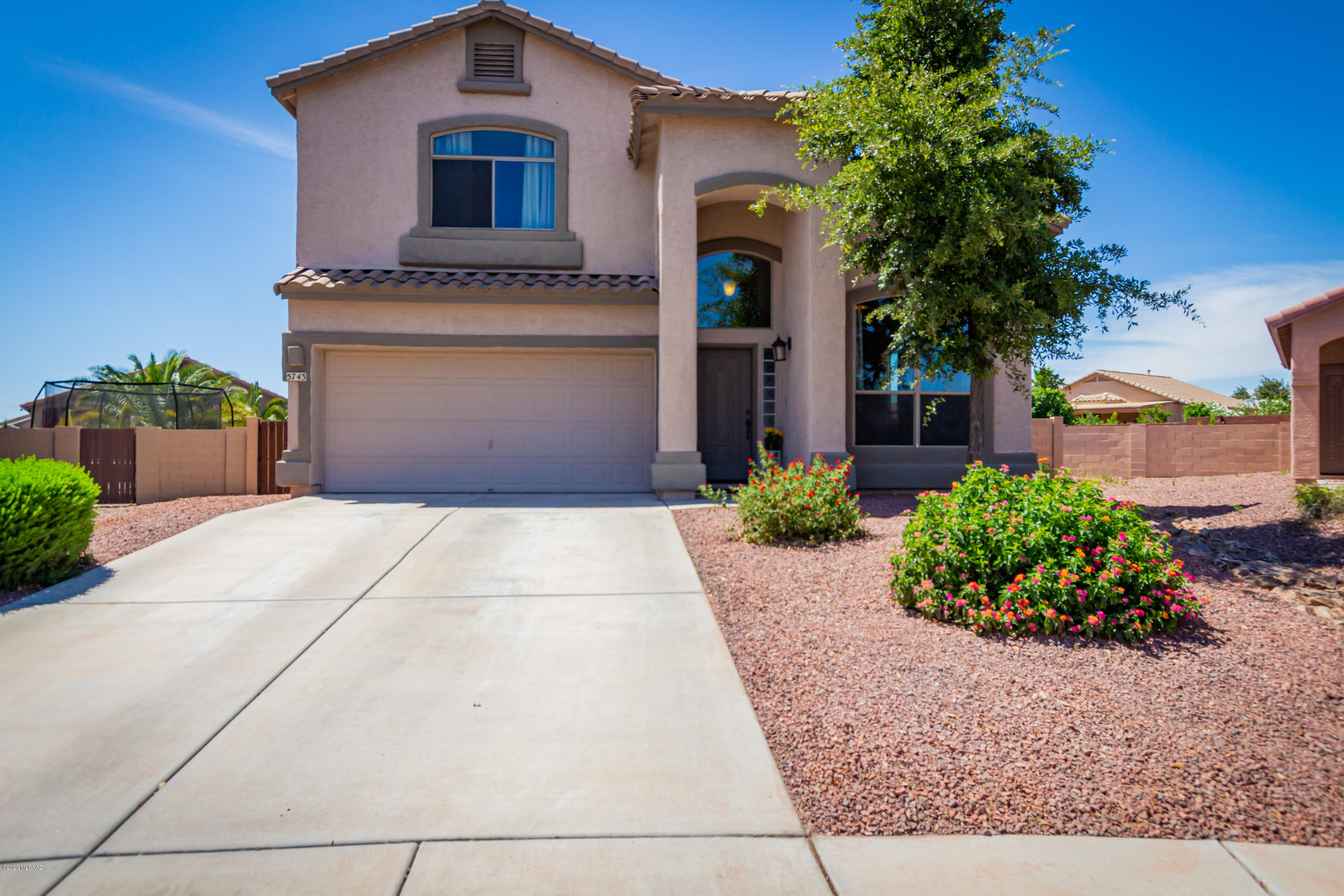 Gorgeous newly updated 4 bed/3 bath home w/ pool within desirable Cortaro Ranch. This corner lot features a large backyard oasis complete with a covered patio, built-in bbq and sparkling pool perfect for entertaining. Must see interior is bright and immaculately maintained. The formal living area boasts dramatic vaulted ceilings and beautiful wood like flooring. Beyond is a spacious open concept family room and kitchen featuring new SS appliances, and a sunny dining nook. Custom paint tones throughout. Upstairs master retreat includes an elegant en-suite with dual vanities, separate garden tub and shower. Great location minutes from I-10, shopping, restaurants and schools. This house is a gem with many recent upgrades and will not last . Be sure to view the 3-D Matterport  virtual tour.