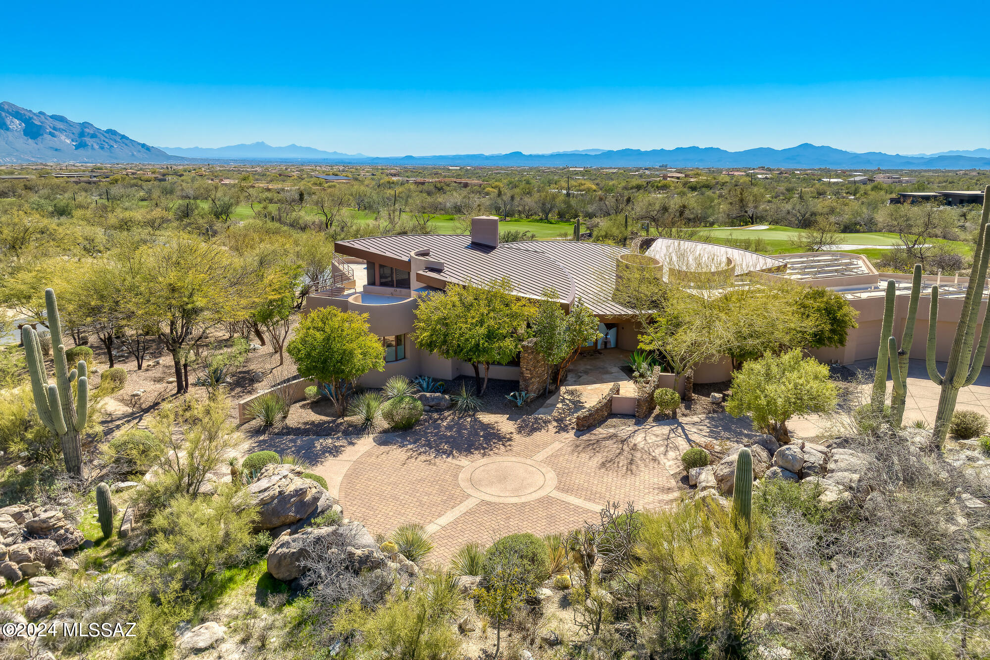 Stunning & dramatic soft contemporary designed by renowned Tucson architect Kevin Howard provides seclusion & sweeping Catalina views across 11th fairway of world-class Stone Canyon golf course. Floor-to-ceiling windows, Limestone floors & high-end finishes all infused with warmth via stone accents to create an inviting yet dramatic luxury residence. Main house (4,343 SF) has fabulous Great Room w/metal clad Fpl, Wetbar w/Wine Ref, Luxury Kitchen, Powder Rm, gorgeous Primary, Guest Suite, large Den & Loft Office w/large deck & views to Tucson. Guest House (542 SF) includes 2nd Guest Suite w/sep Living Area & Kitchenette. Enchanting yard w/negative edge Pool/Spa, misting system. Covered outdoor kitchen w/Fpl offers multiple entertainment areas and mesmerizing views. Club Membership req'd.