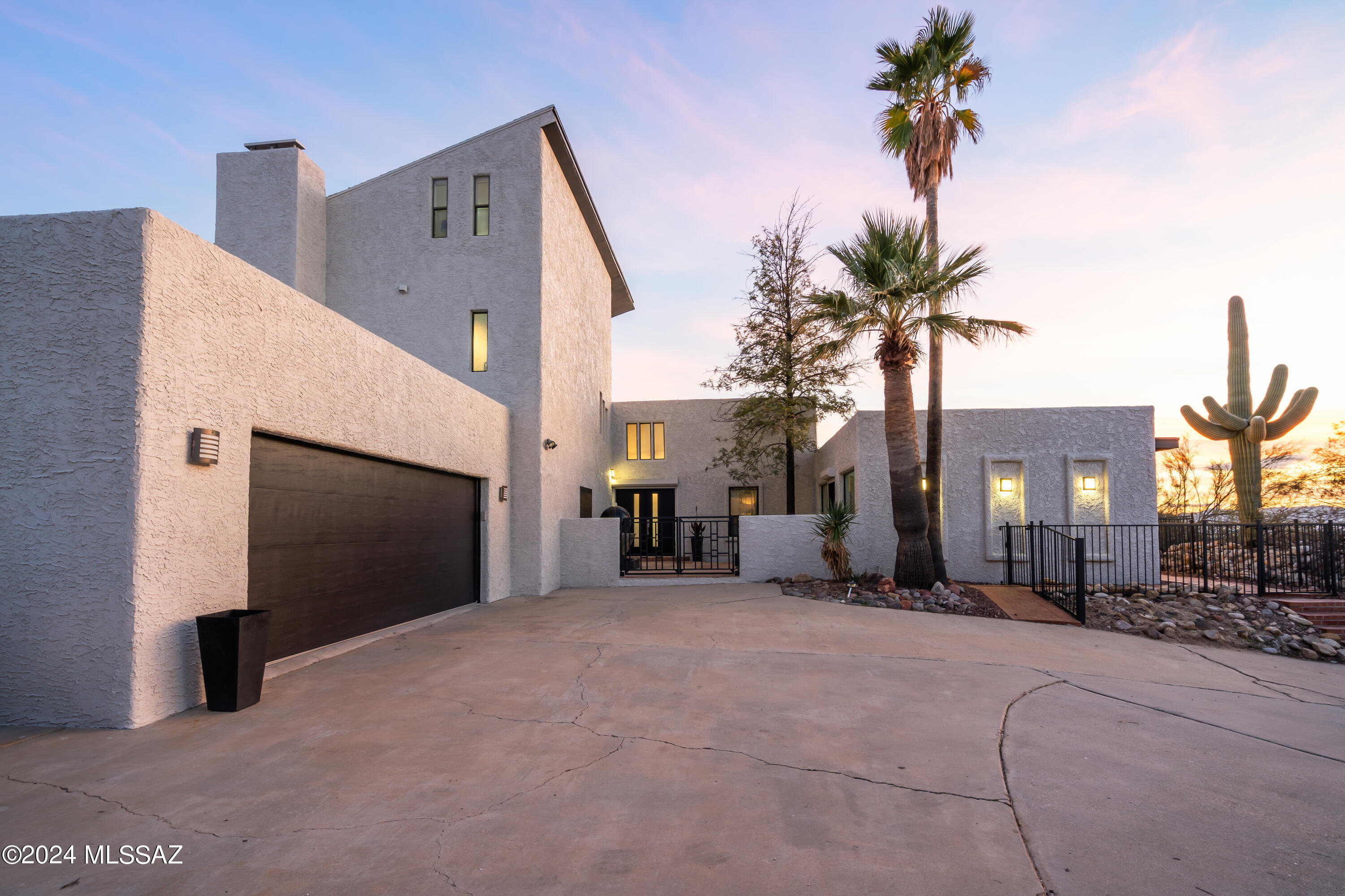 This immaculately renovated 5 bed, 5 bath custom home has room for the entire family on a sprawling 1.82 acres. It features a new kitchen with quartz counters, stainless steel and marble fireplace, Choice between Primary bedroom up stairs or down, large dining room with serving bar, split floor plan, office/den with fireplace, wet bar, zoned heating/cooling, RV parking, dog run/catio and so much more. Enjoy mountain/city views and amazing sunsets from the wraparound yard while entertaining friends/family in a resort style pool. Surrounded by shopping/restaurants easy access to I10. Don't miss out on this desert oasis in Oracle Foothills! Owner is a licensed Real Estate Agent in AZ