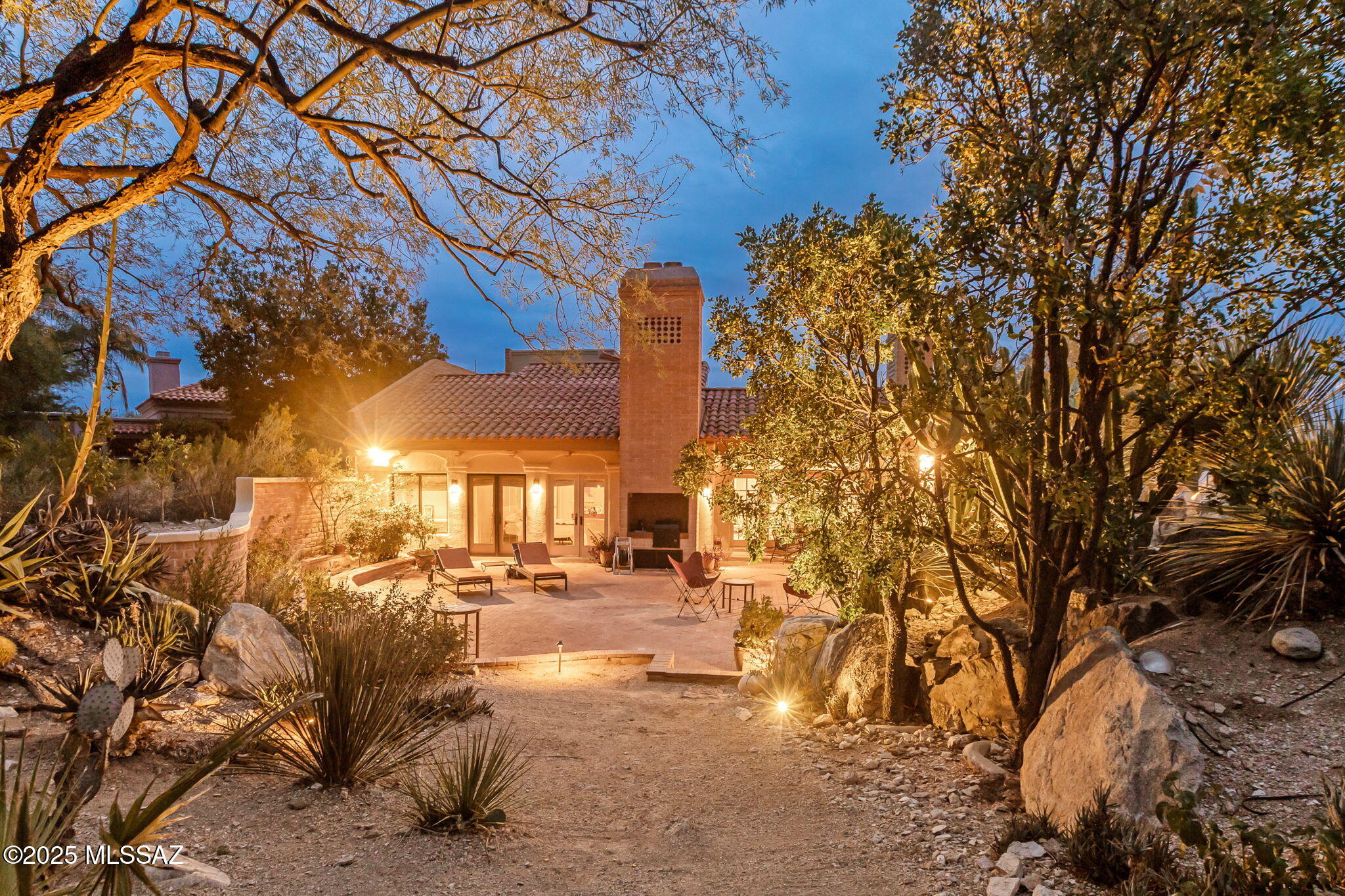 Welcome to your dream home in the prestigious gated community of Finisterra. This 3 bed, 3 bath 3,336 square ft home on a large private lot is nestled into the Catalina foothills with gorgeous mountain views behind.  The synergy of setting & architecture exudes timeless elegance & an impression of meticulous craftsmanship. Up the brick walkway, past the vines, you are led to a charming courtyard entry framed by wrought iron & stucco walls creating a garden like atmosphere. Inside, soaring exposed beam ceilings, 24'' polished marble tiles & French doors fill the home with natural light. Spacious living room features built-in shelving & tiled fireplace surround, while the library offers rich wood-paneled walls, ample shelving complete with rolling ladder for top shelf access. See MORE tab The chef's kitchen is ready for entertaining with Sub-Zero fridge, oven, steamer, beverage fridge, island cooktop, & abundant quartz counters. The primary suite is a true retreat with vaulted ceilings + fireplace. Added bonus room through pocket doors for an office or workout room. French doors leading you outside for foothill views, & a spa-inspired bath with skylight, marble surround, & soaking tub. Bedroom #2 is truly a second primary. Upstairs bedroom creates the feeling of a spacious loft which opens to a Juliette balcony replete with birdsong from the mature Mesquite tree off the balcony. Backyard is situated at the base of a Saguaro coved hill featuring a brick-lined patio with natural rock fountain. 3-car garage, large Laundry room, storage, & Catalina Foothills district 16 schools. Community offers many amenities including Pickle Ball, Tennis, Pool, Spa & Club House + a manned gate. This home blends privacy, comfort, sophistication, & desert beauty.