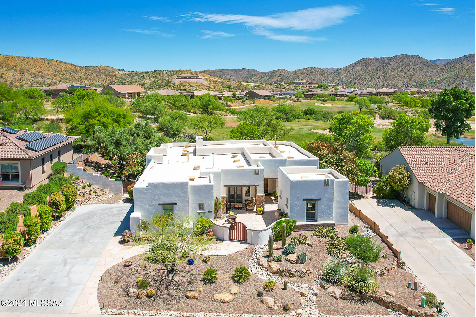Resort style living at its finest in The Preserve at SaddleBrooke! This luxurious 2,681sf Sabino model boasts a gated front Courtyard with flagstone pavers and detached 300sf Casita with private entry for a total of 2,981sf of gorgeous living space. Open concept plan for modern living affords dual primary suites (each with bay window and patio access) plus den/office and powder room. This exquisite home resides on a premium .31 acre view lot bordering the 11th fairway and offering panoramic mountain and golf course views. Elegant foyer with tray ceiling adjoins a large den/office with glass-paned French doors. Beyond lies a Great room highlighted by wood-look porcelain plank flooring, elegant tray ceiling, impressive stacked-stone media/display wall with gas fireplace, plus picture window and sliding glass door with rolling security shutters. Gourmet kitchen boasts granite countertops, hickory cabinets, stainless or black appliances including a Viking 6-burner gas cooktop, dining nook with courtyard access, inner & outer islands (each with breakfast bar) plus walk-in pantry. Retreat to the main primary suite with plush carpeting. Luxury bath hosts porcelain flooring, dual granite-top vanities, jetted tub with glass block window; huge, tiled walk-in shower with bench seat; plus large customized walk-in closet. Second carpeted primary suite hosts a tiled walk-in shower and walk-in closet. Detached casita off courtyard offers porcelain flooring, a built-in buffet, and luxury bath with tiled walk-in shower. Extended laundry is equipped with storage cabinets, workspace and utility sink. Additional amenities include plantation shutters, zoned heating/air conditioning, alarm system plus 3-car side garage with storage cabinets. Relax or entertain in the expansive rear yard with extended flagstone pavers, view fence, and powered rolling sunshades that fully enclose the covered patio. You'll also enjoy a woodburning kiva fireplace, trickling fountain, lush desert landscaping with mature shade trees, plus panoramic mountain and golf course views. SaddleBrooke is Tucson's Premier Active Adult Community offering a clubhouse, restaurant, fitness center, championship golf course, multiple sport courts, plus Performing Arts Center. Perfect for the most discerning buyer!