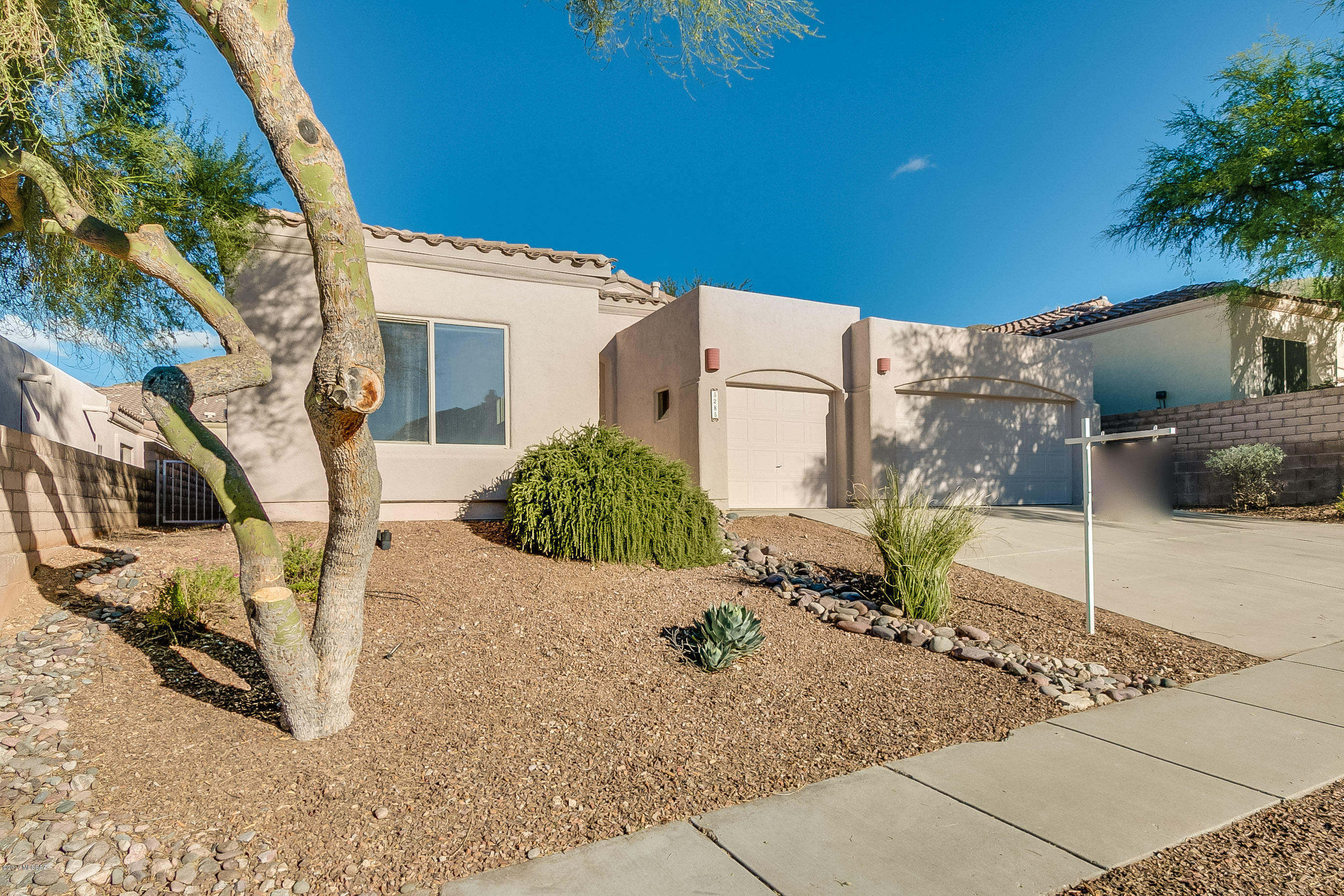 DESIGN YOUR OWN BACKYARD OASIS WITH MONEY SAVED AT THIS GREATLY REDUCED PRICE! This gated community, home to Arizona National Golf Club, is move-in ready and waiting for YOU!  The spacious 2300 sq.ft floor plan is open and bright. The large kitchen with abundant storage overlooks the family room that features a corner built-in area. A fireplace graces the living room. It has a split bedroom plan with 3 bedrooms and a den/office, 3 baths, and a 3-car garage. Numerous ceiling fans. Interior newly painted. New carpet. A/C installed 6/2016. A water harvesting system is installed in backyard.
