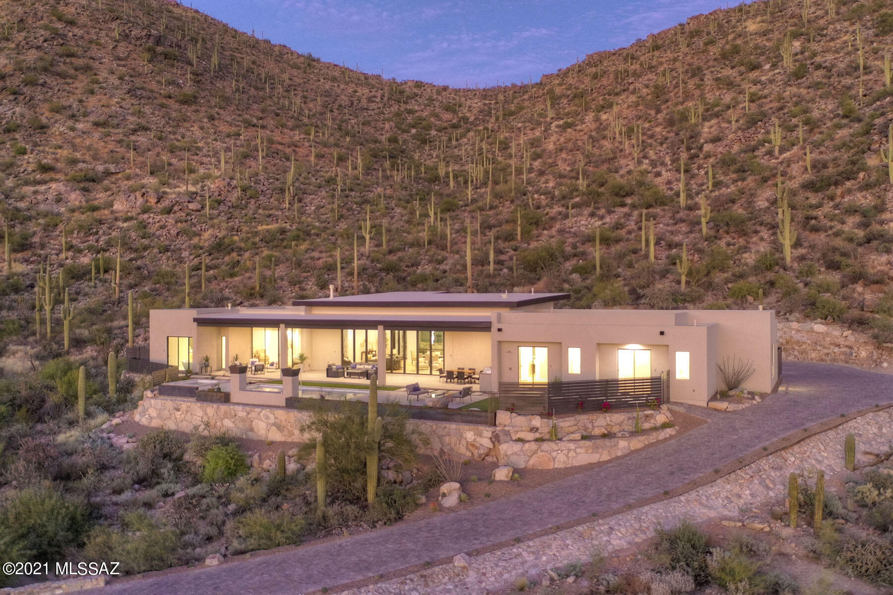 JUST COMPLETED!!!
''WOW'' is the first word out of everyone's mouth when they see the amazing setting, quality finishes, & open and expansive layout of this spectacular home. This newly constructed home is now complete and ready for viewing! It sits up high on a cul-de-sac in the exclusive gated Gallery Canyon Community of only 15 estate lots. Cobblestone streets lead you up to sweeping valley views and a saguaro studded canyon. Very Private with over 50 acres of adjacent natural open space. Check out the walls of glass everywhere you look. Split floor plan. No interior steps. This is an entertainer's paradise with expansive outdoor living areas. Walking distance to the Gallery Country Club restaurant and golf facilities. If you are looking for something special, this is it! Engineered hardwood flooring and porcelain tile. Firepit, pool fire feature, and water spillways are amazing. Taj mahal quartzite countertops in the kitchen with waterfall sides on the island. Luxury high end appliance package including Sub-Zero fridge and 60" Wolf Range. Huge walk in pantry off kitchen. Elevated putting green / additional patio for entertaining in front. 24' Panoramic sliding glass door system that fully opens to the rear yard covered patio. Impressive 10' high metal and glass single pivot entry door. Amazing outdoor kitchen. Come see the best!