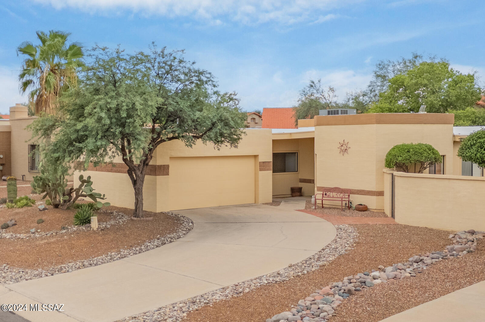 Nestled in the serene Acacia Park subdivision, this delightful 2-bedroom, 2-bathroom home offers a perfect blend of comfort and tranquility. The spacious great room, featuring a classic beehive fireplace, will enhance a cozy evening. The great room opens into a full-length covered patio, ideal for outdoor living and entertaining. The backyard is a private oasis, boasting mature fruit trees and a charming fountain, an ideal sojourn of rest and relaxation. Acacia Park offers an array of community amenities, including a refreshing pool, a play area and a small park with picturesque walking trails. This property is a hidden gem in Northeast Tucson, providing a wonderful opportunity for comfortable living in a welcoming neighborhood.