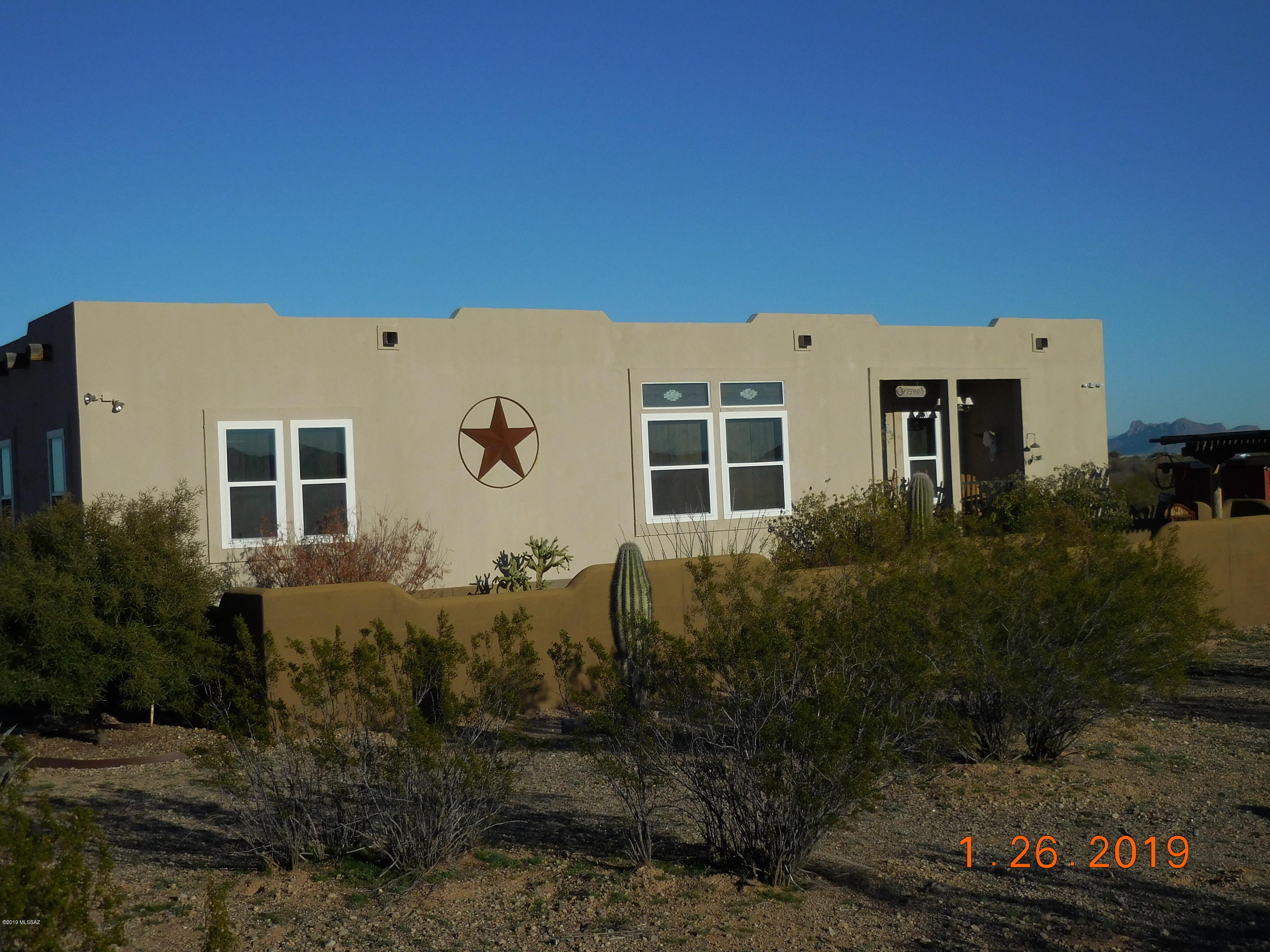 Deal fell through and Seller is wanting to move ASAP and has done a HUGE price drop to make this happen.  2005 Santa Fe style home that is affixed on concrete blocks foundation.  Beautiful mountain views from all sides, numerous updates:  New windows, new roof cover, front portico, rear covered patio, one car garage, work shed , animal shed, fire pit, BBQ area.  Lot is mostly fenced and has a small horse corral.  The home is beautifully kept and decorated.  The Refrigerator and Washer and Dryer will go with home.  Some of the furniture  and fixtures can be purchased on a seperate Bill of Sale.  This home is ready to move in for the next buyer.