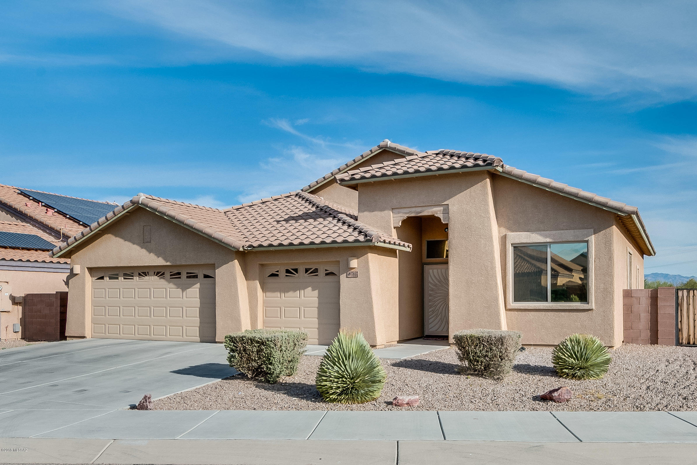 Model home perfection! Spotless. No carpet. 18 in tile and upper-grade laminate floors throughout. Home backs up to riparian area - no peeking neighbors!  Spacious mst bedroom w/in-suite bath.  Separate shower/tub. Walk-in closet. Other two bedrooms are good size. Custom plantation shutters on majority of windows - also professionally installed window tinting keeps home cooler in summer months!  Kitchen island & counters all granite - LOADS of cherry cabinets/pantry.  Custom paint throughout - Lovely Catalina & Rincon Mtn views. Garage has full wall of built-in cabinets. Formal liv rm as well as large fam rm right off kitchen. Fam room/kit door leads to covered patio - perfect for entertaining. Low care front & back yards. Newer H20 heater. Vail district & park nearby.