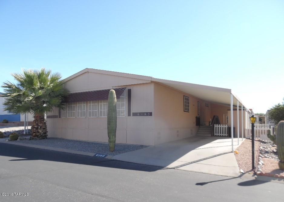 Unbelievable PRice! Spacious 2 bedroom 2BA home has a family room off kitchen that sports a sliding glass door on to 20' deck. Nice views emanate from porch with steps both to the front of home and back to landscaped yards. The front LR and dining area are bathed in soft light and the bedrooms are large with good size closets + a Master bath has oversized linen closet. Open hallway has built in cabinet. Large laundry room has cabinets, counters & drawers. Nice 8X12 storage shed with wall ac. Enjoy 55+ community w/clubhouse, pool, spas, fun activities.