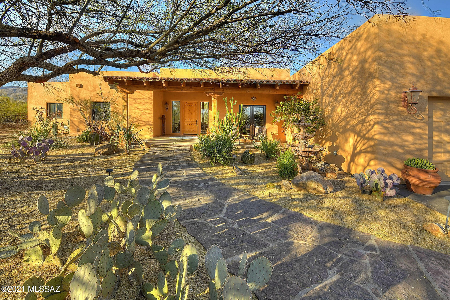 Private custom home & horse property in beautiful Tanque Verde Valley. This 3462 sq ft 5 bed 3 bath home nestled amongst mesquite trees & saguaros sits on 3.52 ac w/direct wash & trail access. Shaded horse arena, tack room, & water/electricity to facilities. Inside enjoy gorgeous views from floor to ceiling windows, exposed beams, & hardwood floors. Chef's kitchen w/6-burner Viking range, large mesquite wood island w/ample seating, & all SS appliances. Master suite features beehive fireplace, patio access, large spa-like bath, & huge walk-in closet. Space for entertaining w/large bonus/family room & open concept living room. Step outside to a large, covered patio or take a dip in your sparkling pool. Backyard has fenced area w/real grass. 3-car garage w/epoxy floors, & workshop. No HOA!!