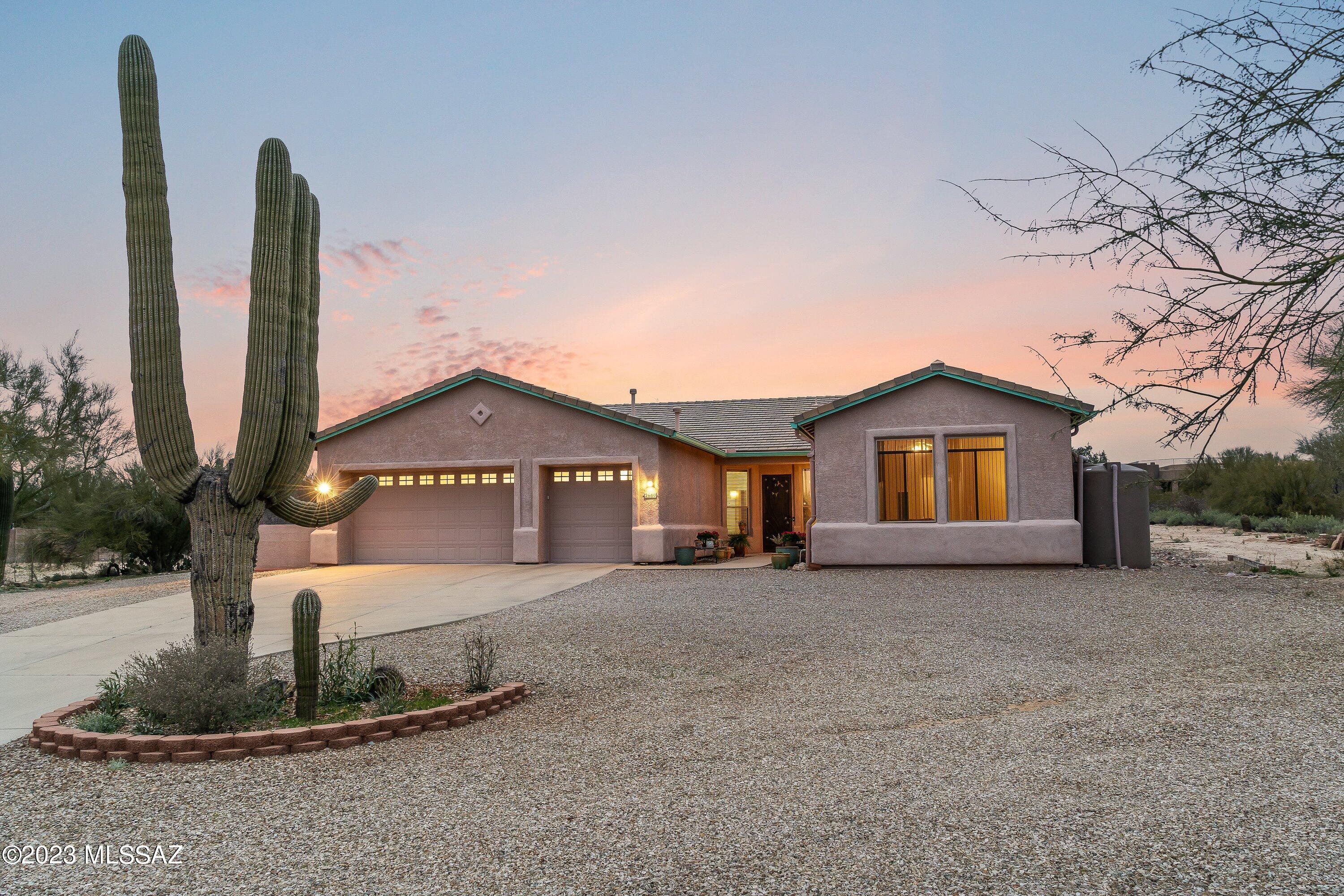 Saguaro Studded Oasis!
Peaceful and private desert setting with mountain views and no HOA! Split floor plan with 2 large master suites. Chefs kitchen with large island, gas cooktop, walk in pantry and lots of storage. Large craft room is ready to use or can easily be converted to a den, office or extra bedroom. Peaceful backyard garden includes a stand alone workshop with mini-split AC. Wheelchair accessibility features include roll in thresholds on all external entry doors, large roll in showers in both master suites, wide hallways & doorways throughout. Low care xeriscape landscaping, drip irrigation, rainwater capture system, dual pane windows, sun screens, North/South exposure, & dual cooling. New HVACs installed in 2019. Deep 3 car garage plus RV parking w/ water & 30 amp service. - 12x14 Workshop (168 sq/ft) with mini split and the pergola built in 2020.  
- Custom window coverings throughout plus custom iron security doors & gates.
- The rain water capture system was installed in Nov 2019 and includes two 530 gal tanks and one 1150 gal tank.
- Energy saving Green features include low care xeriscape landscaping, drip irrigation, 2210 gal rain water capture system, dual pane windows with external sun screens, North/South exposure, and dual cooling (evaporative coolers + air conditioners).