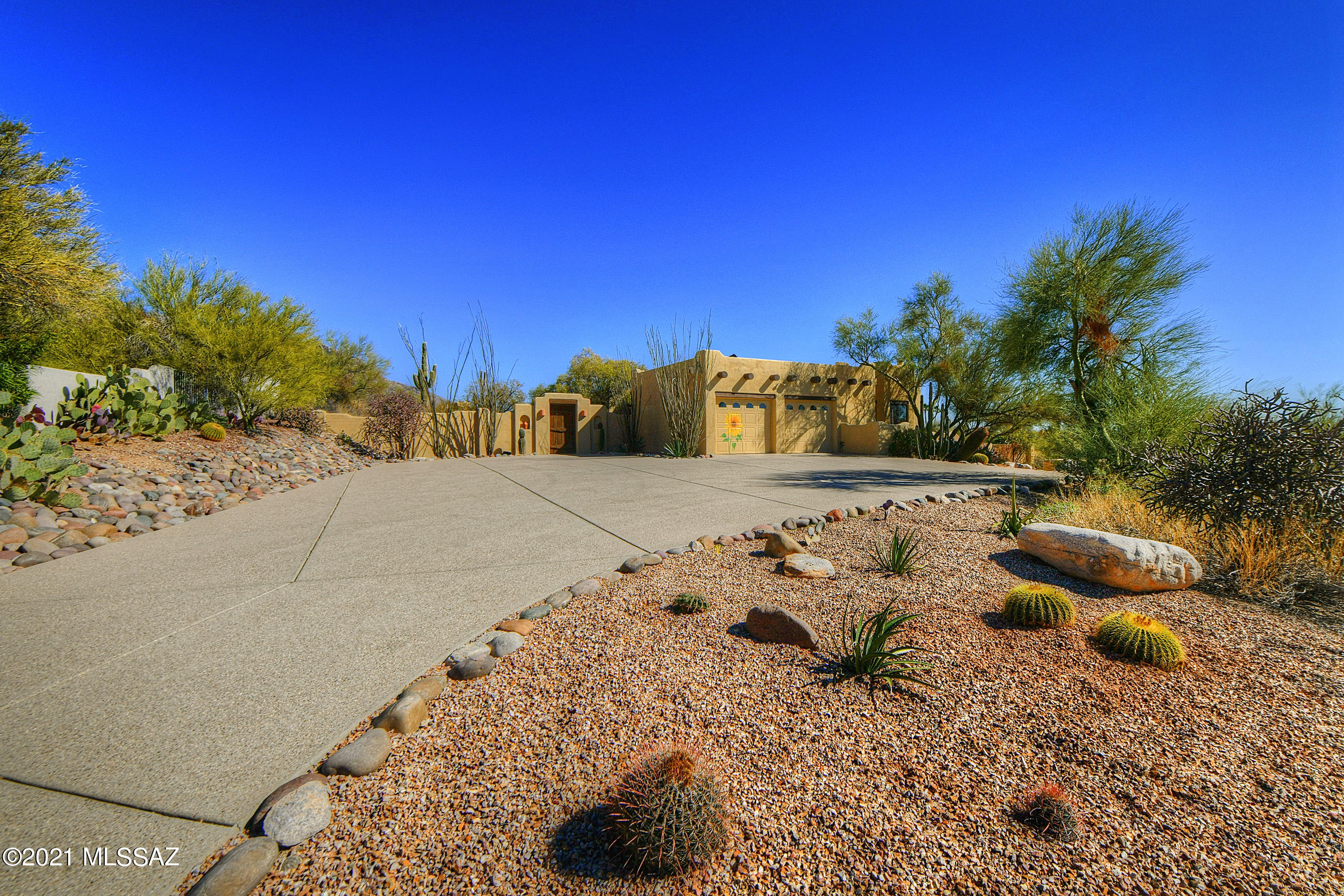 Beautiful Santa Fe on an elevated one acre lot with wonderful views of the Tucson City lights & Catalina Mountain Range.  Everything inside on one level, lovely accent white wasched viga beams & oozing with santa fe charm.  4 bedrooms/3 full baths, ceramic Mexican tile, dramatic- beamed high ceilings, granite counter tops in Kitchen, 2 charming fireplaces (one in Owners suite)...Enter into a lovely walled in courtyard with Mountain views, double glass french doors lead into the house with immediate views out to the back yard featuring city lights beyond a wonderful Pool & Spa.  Great entertaining home in one of the best foothills neighborhoods and NO HOA fee.