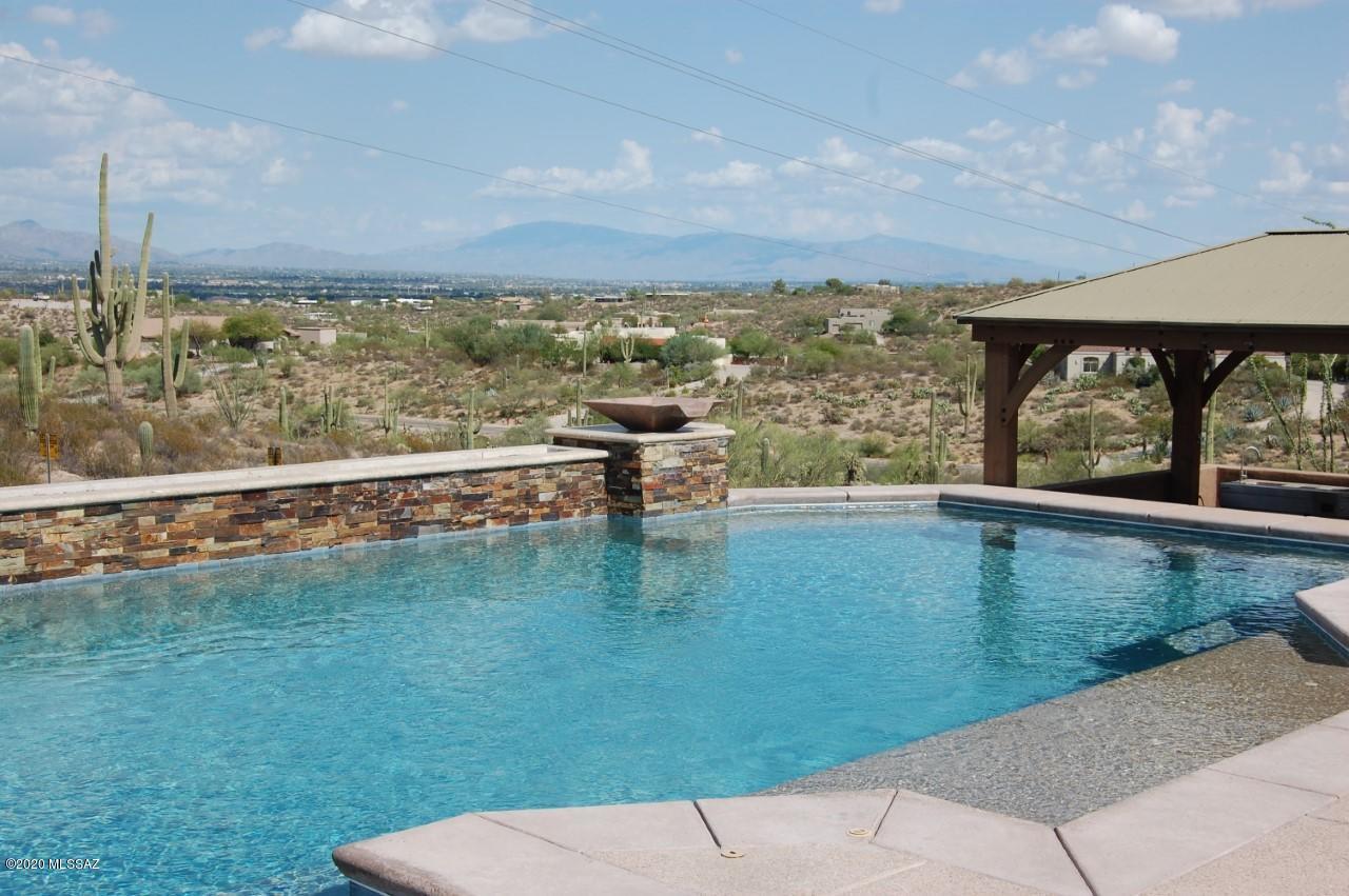 Tucson Mountain Reserve finest! Incredible mountain views, backs to Saguaro Nation Park. This home provides more than enough entertainment in this COVID-19 times. 24X30 Game Room w/full bar. Total home theater system with surround sound and 3 tier leather seating! Outdoor entertainment w/gazebo and outdoor grill w/sink and refrigerator. Heated pool with twin water features, swim-up bar and gas fire feature. This unique 6BR/6BA home has it all!... and that is not all, for the car enthusiast there is a 3 car garage with separate 30X50 RV garage w/full hookups! Take the virtual tour and see this beautiful home as never before!