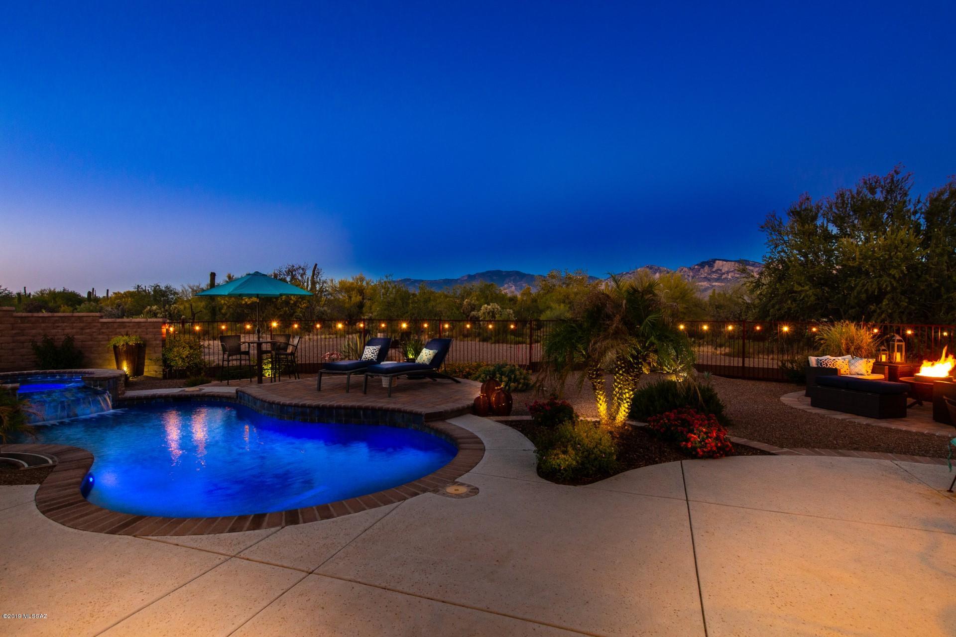Seller will accept or counter all offers between 899,000 and 939,000. Welcome to Coyote Blue Estates and it's Majestic Mountain Views! Gorgeous custom home in a high end gated enclave with private 3.3 acre parcels.    Home hosts a Chefs Gourmet kitchen, formal dining, family room with fire place, media room and Generational suite. Spacious master suite with free standing relaxing tub and access to the backyard. The oasis is complete with pool, jacuzzi, built in BBQ, fire pit, and so much more. Luxury in the desert! Come take a View!
