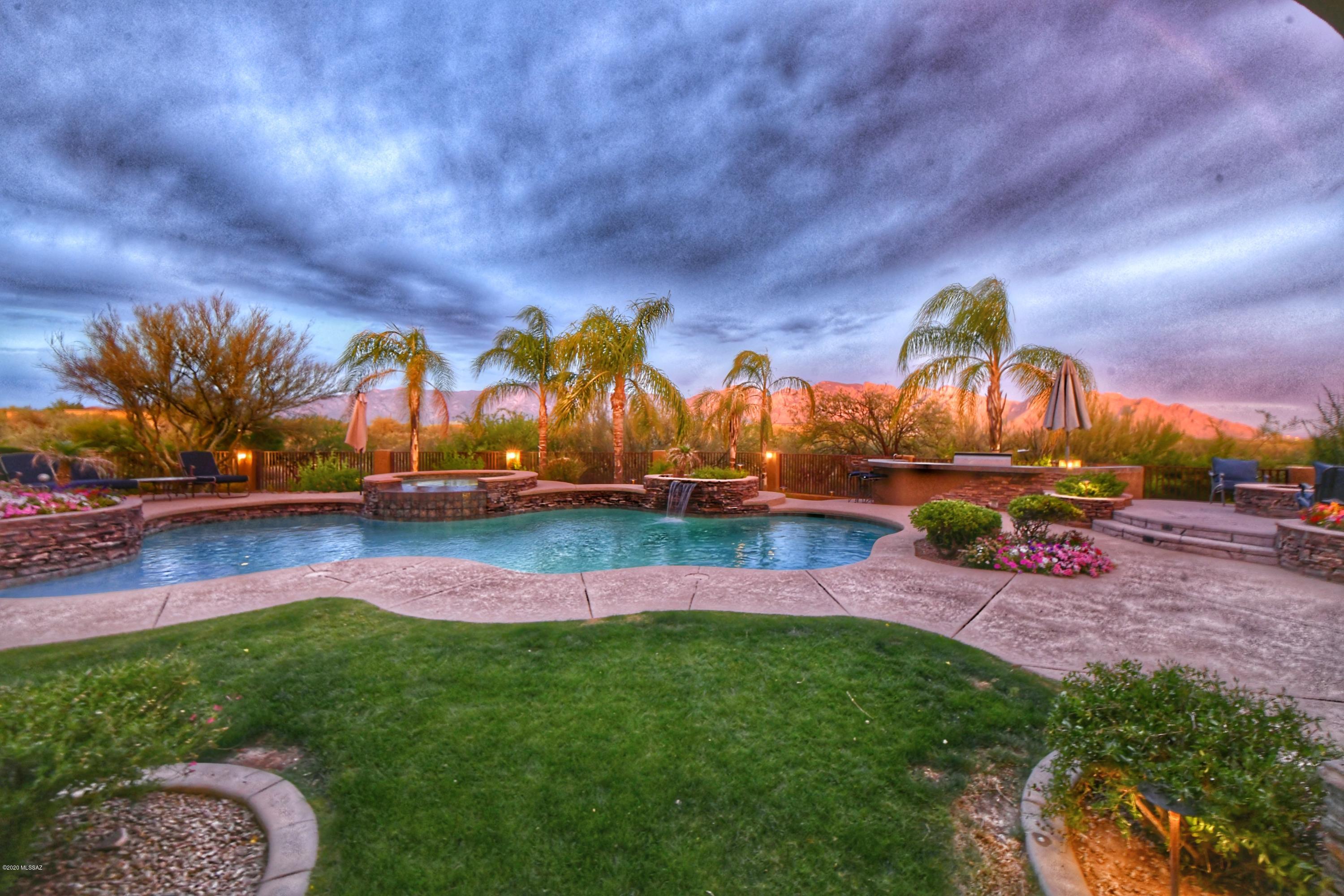 VIRTUAL TOUR! Vacation in your own backyard with beautiful landscaping.  Escape to your refreshing swimming pool and in ground Trampoline, Gas Fire pit, Outdoor BBQ Kitchen. Outdoor Living at its finest with Firepit and Television. Relax and entertain in this amazing Backyard with Panoramic MOUNTAIN VIEWS. Stare at the Stars and City Lights from anywhere in the backyard.  Gourmet Kitchen includes: Granite Counter Tops, Stainless Steel Appliances, 5 Burner Gas Cooktop on Island. Open and Bright Great Room.  Master Suite has a spa-like bathroom with Jetted Tub. ALL Bedrooms have access to their own Full Bathrooms. ABUNDANT storage and walk in closets. In floor vacuum system. Nest A/C thermometer devices throughout the home help save energy.  New ceiling fans on outdoor covered patio. Washer/Dryer, Garage Refrigerator, Freezer, Ice Maker, Barn Door do not convey.