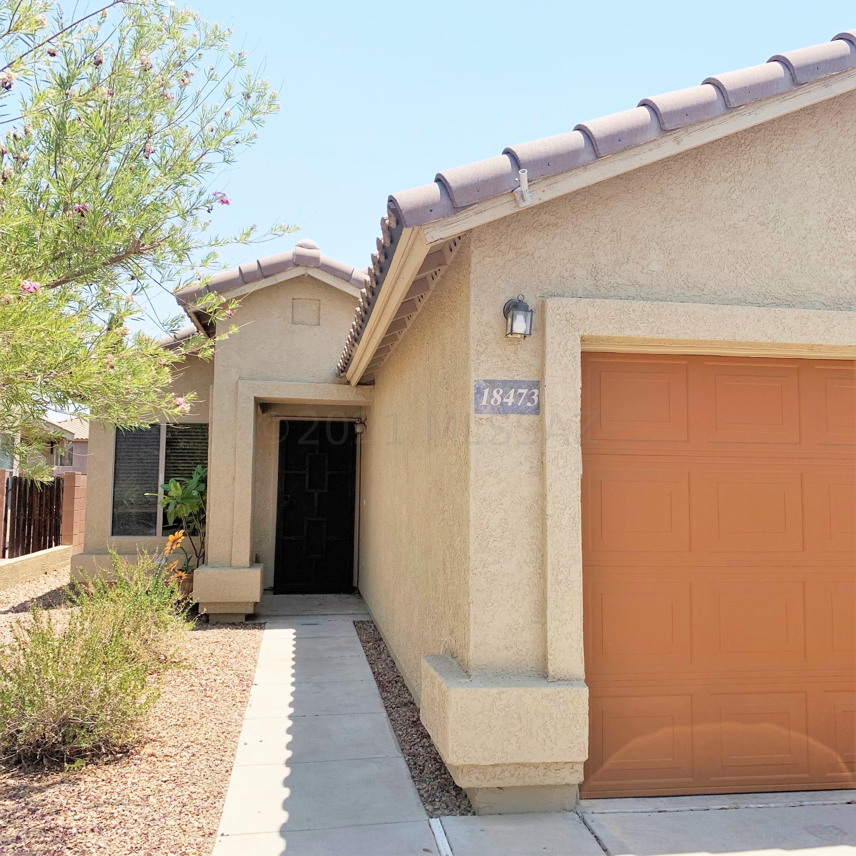 Perfect starter home in an ideal location! This home offers 3 bedrooms, 2 bathrooms, plus a formal living room. Upgraded with tile floors throughout, stainless steel appliances and contemporary kitchen backsplash and a custom wrought iron security door. Enjoy the mountain view outside under the covered patio, while enjoying fresh pomegranates off of your own tree.  With leased solar, your home is energy efficient for these hot summer days! This home is within walking distance to shopping and dining, and quick access to I-19.