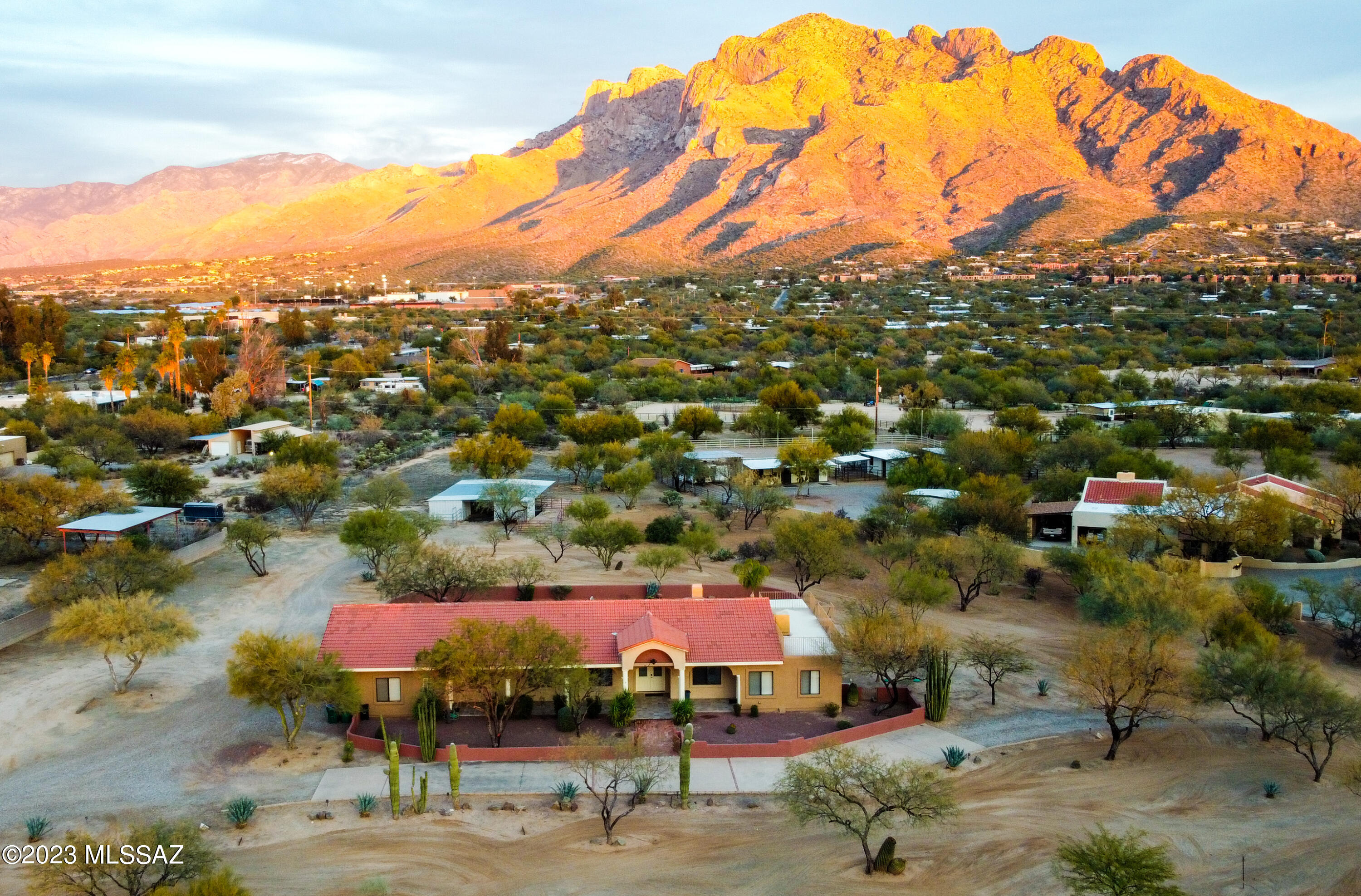 Amazing opportunity to own a ranch ''in town''!  With facilities, this 2 x 6 construction home sits on a 3.3 acre view lot.  Step into this Mediterranean masterpiece w/windows that frame the towering Catalina Mtns! Custom built, enjoy set in nooks, see-through fireplace, high ceilings, new appliances, fresh paint, extra room w/outside entry suitable for office, den, bedroom or guest area. So much storage! Extra insulation in the home saves on summer AC bills.  Gorgeous chandeliers convey!  Three stall garage plus workshop & built-ins, plus full facilities for your horses. Barn has 4 stalls, enclosed hay storage, waterers, wash rack, tack room,  corrals & turnouts. Spacious grounds w/courtyard ''formal'' lawn and garden areas. Nearby trails, easy access to shopping, restaurants & more