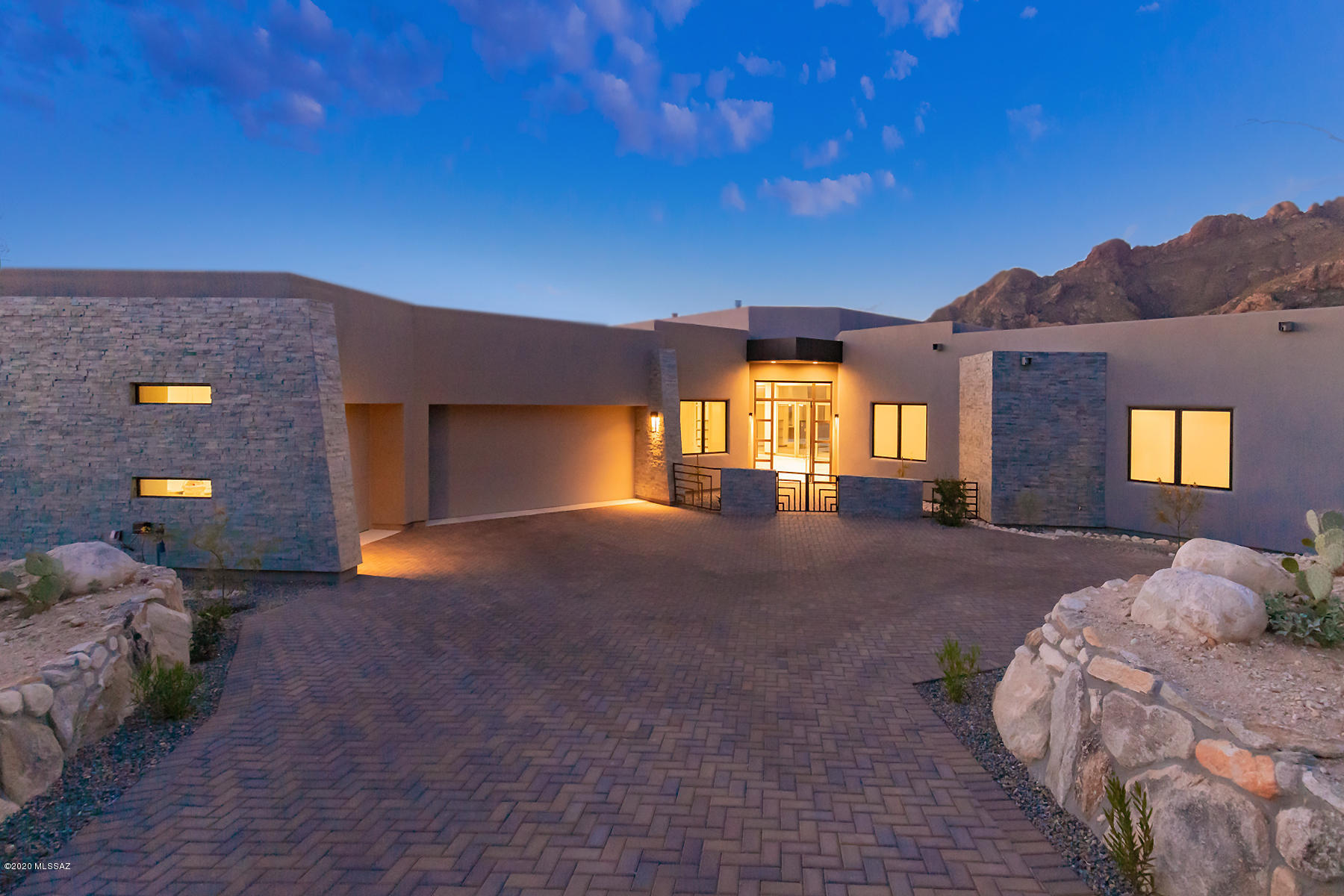 This 2020 stunning new construction features interiors by nationally renowned designer Lori  Carroll & Assoc. Located in prestigious Pima Canyon Est., this home showcases sleek contemporary lines that is designed for large scale entertaining. The coffered ceiling DR with pendant chandelier & LR with a see through FP flows to outdoor living spaces via walls of glass that blur the lines between indoor & outdoor living. Enjoy unobstructed views of the Catalina Mountains from resort style pool/spa area with built-in BBQ. Gourmet kitchen with professionally inspired SS appliances & granite/quartzite counters effortlessly flows into the Family Room that features a leathered stone & metal fireplace. Master suite offers dramatic mountain views, incredible walk-in closet & spectacular bathroom.