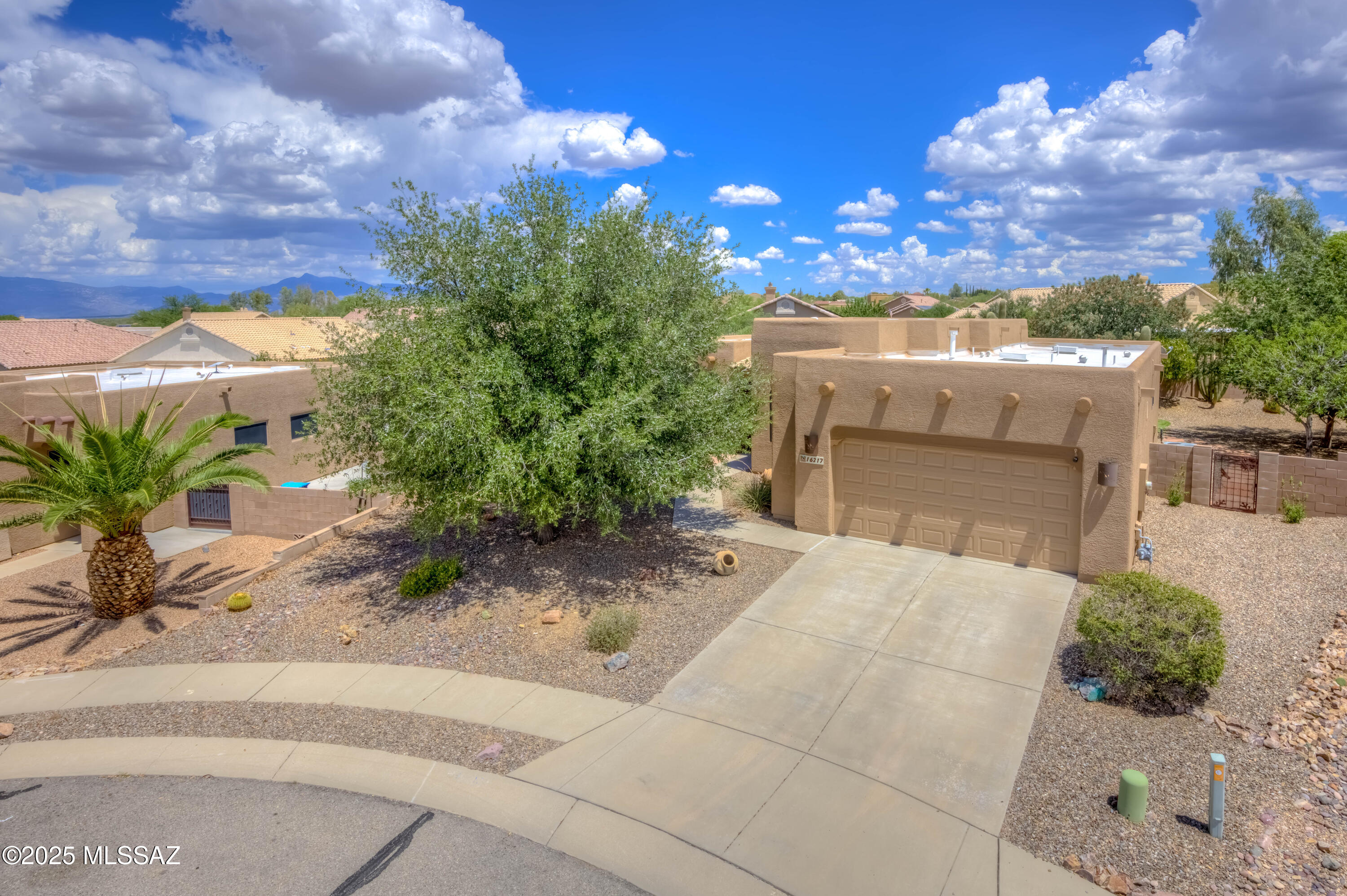 Located on a quiet cul-de-sac in the highly sought-after Vail School District, this beautifully maintained 3 bedroom, 2 bathroom home offers 1,845 sq ft of well-designed living space on nearly a quarter-acre lot, perfect for those who crave space, privacy, and scenic views. Inside, you'll find an open-concept layout with impressive 12-foot ceilings in the great room and ceramic tile floors throughout. The spacious kitchen is a standout with granite slab counters, a large island, gas cooktop, double ovens, cabinet pullouts, and a breakfast bar, all connected to the cozy dining area, ideal for both everyday living and entertaining. The LARGE master suite offers a peaceful retreat with a walk-in closet and a luxurious en-suite bath featuring double vanities with vessel sinks. The hall bathroom echoes the same upscale finishes with granite counters, vessel sinks, decorative mirrors, and upgraded lighting. Additional hallway cabinets and countertop space provide convenient extra storage. Step outside to an extended covered flagstone patio, a serene space to enjoy your morning coffee or evening gatherings while soaking in the breathtaking views of the Santa Rita Mountains. The private backyard includes a play structure and plenty of space to make your own, while the front courtyard with built in seating is the perfect place to take in the amazing Arizona sunsets. Additional highlights include security screens, brand-new exterior paint, a water softener, and thoughtful design touches throughout.
