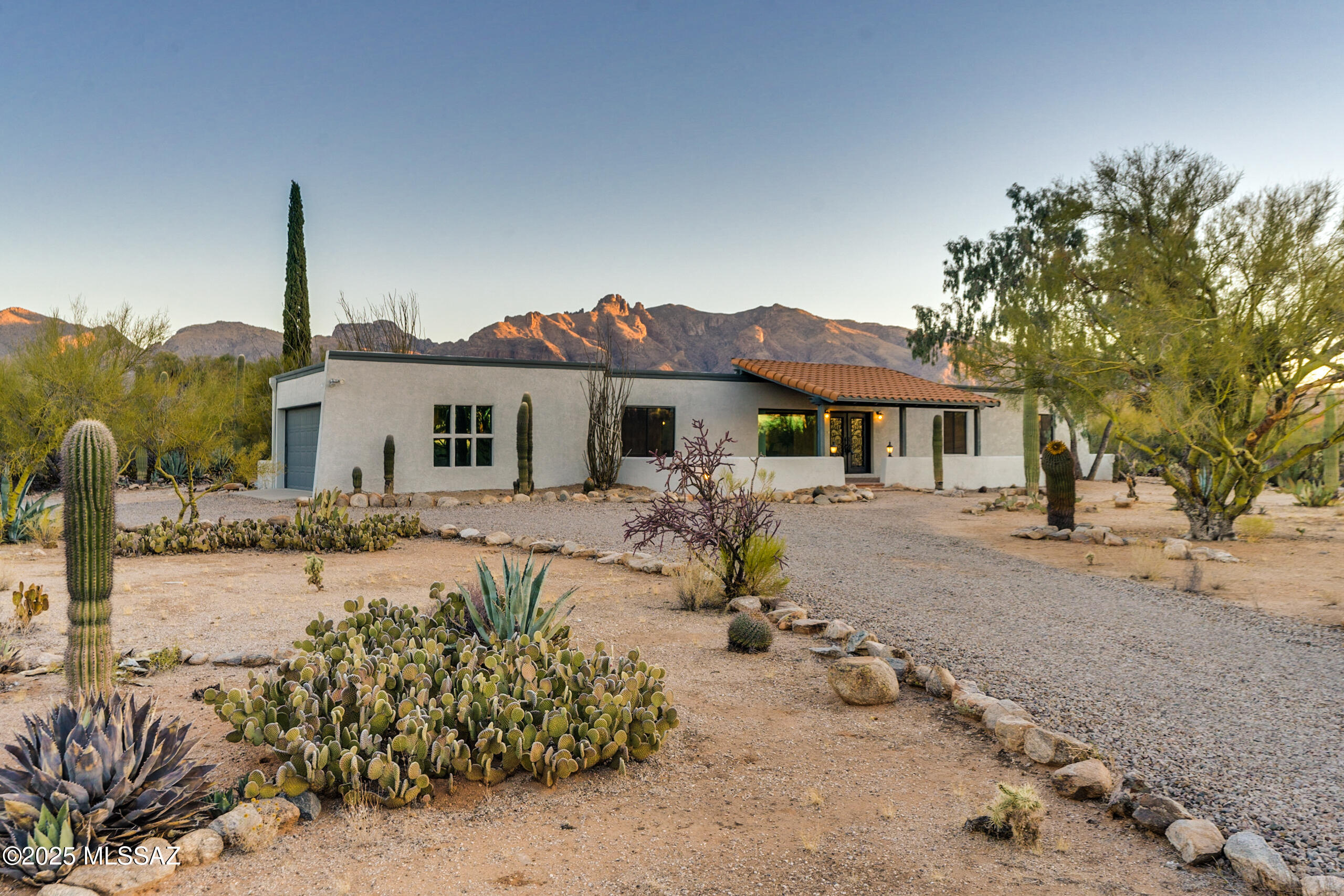 Welcome to this stunning updated 4-bedroom, 3-bath home, offering 2,611 sq ft of luxurious living space, complete with a sparkling pool. As you approach the home, you'll be greeted by impressive iron double front doors, which open to a spacious walled covered front patio. Step inside to the expansive great room, where large windows flood the space with natural light and offer beautiful views.
The home features wood-like tile flooring throughout, with plush carpeting in the bedrooms for added comfort. French doors lead from the great room to the backyard, where you'll find a covered patio and pool - perfect for relaxing or entertaining.
The gourmet kitchen boasts sleek granite countertops and a stylish tile backsplash. A convenient bedroom located just off the kitchen provides an idea