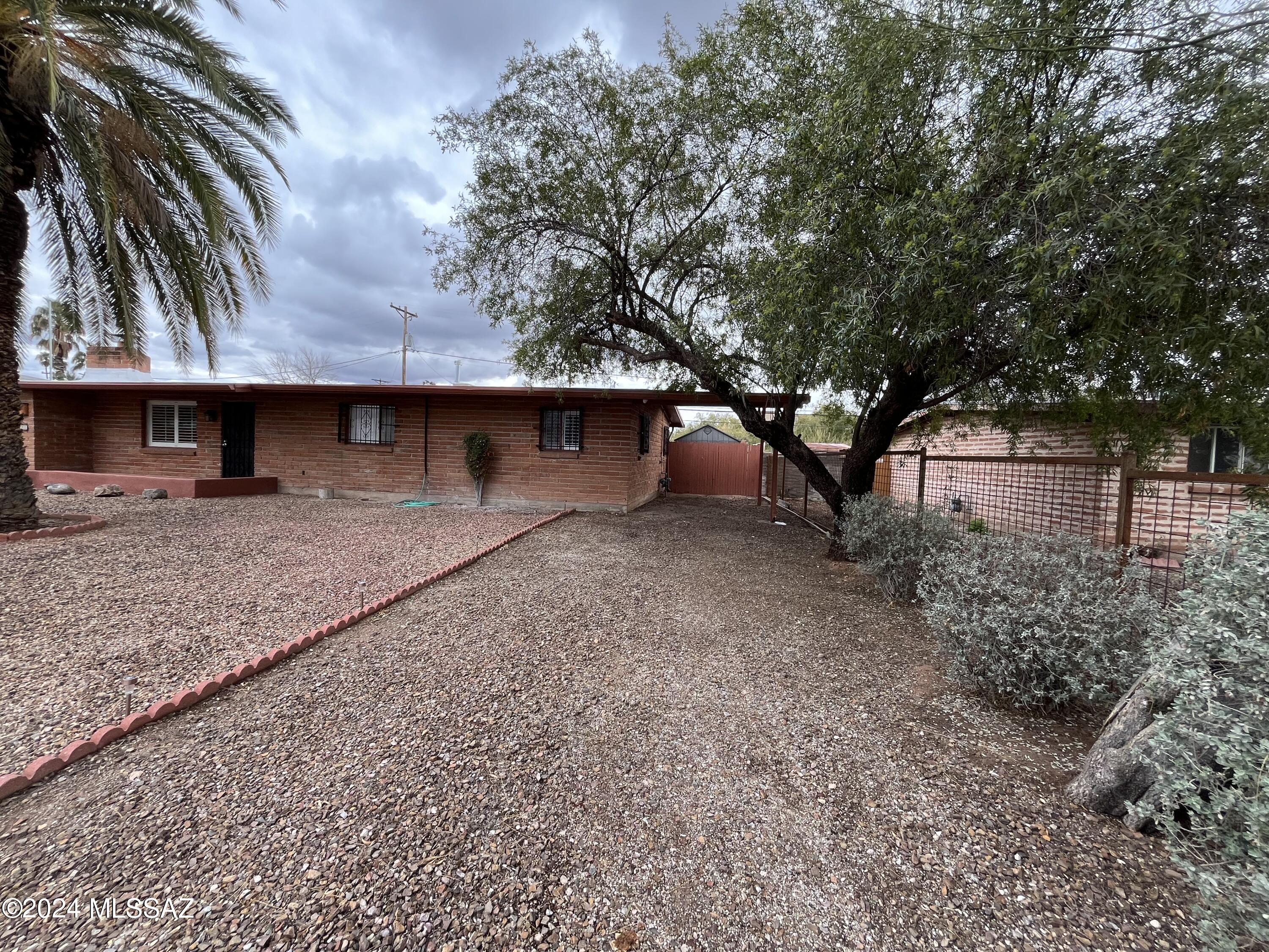 Updated and upgraded! Centrally located home featuring vaulted ceilings, fresh paint, new carpet in the bedrooms plus other nice little touches you can only find in this type of home. Fully remodeled kitchen with marble counter tops, new appliances, and loads of storage with open shelving and plenty of cabinets. Three-bedroom two bath plus den includes Saltillo tile everywhere but the bedrooms and den. HUGE yard that backs to a wash including a covered patio and gazebo for outdoor living. Close to shopping, dining, TMC, and all the cool things Tucson has to offer.