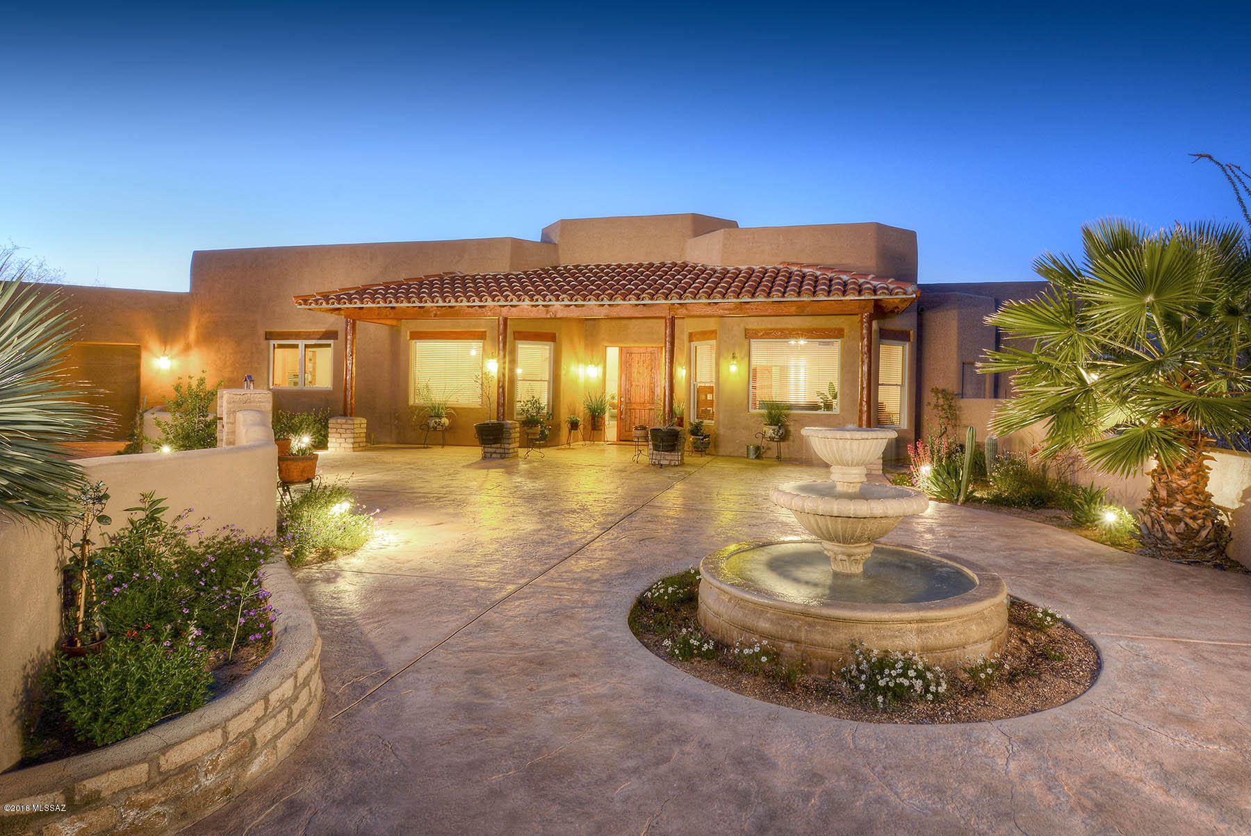 Outstanding southwestern style home on 2.93 lush desert acres with unobstructed Catalina and Rincon Mtn. views in prestigious Palo Verde Ranch.  With 3,880 sq. ft., 4 bedrooms and 3 ½ baths, a courtyard entry with fountain leads into living room with soaring ceilings, walls of windows, fireplace and scored concrete floors.  Included are formal dining room, family room/chef's kitchen with center island, granite counters, stainless steel appliances, gas range and fireplace.  Gracious master suite and bath feature travertine floors and surrounds, fireplace, steam shower and walk-in closet.  Three car garage, glorious rear yard with pool/spa, waterfall, BBQ, kiva fireplace with bancos and Tanque Verde School District.