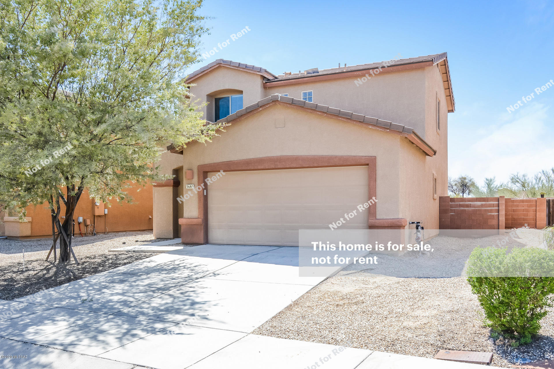 This Tucson two story home offers tile flooring, a kitchen pantry, a covered patio, and a two-car garage.