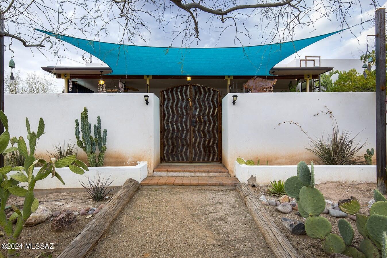 Seamless blend of the old & the new! 1914 adobe was expanded upon in 2015, to create this stunning Barrio Santa Rosa beauty.  Spacious 1711 sq ft, with cozy living spaces, three spacious bedrooms, two full baths.  Experience the joys of outdoor living:  lush patios, privacy walls, and a home that will amaze buyers looking for authenticity and creativity in a downtown setting.  Murals by local artists, gorgeous woodwork, custom tile, truly you must see this in person. Enjoy the 3-D matterport tour!