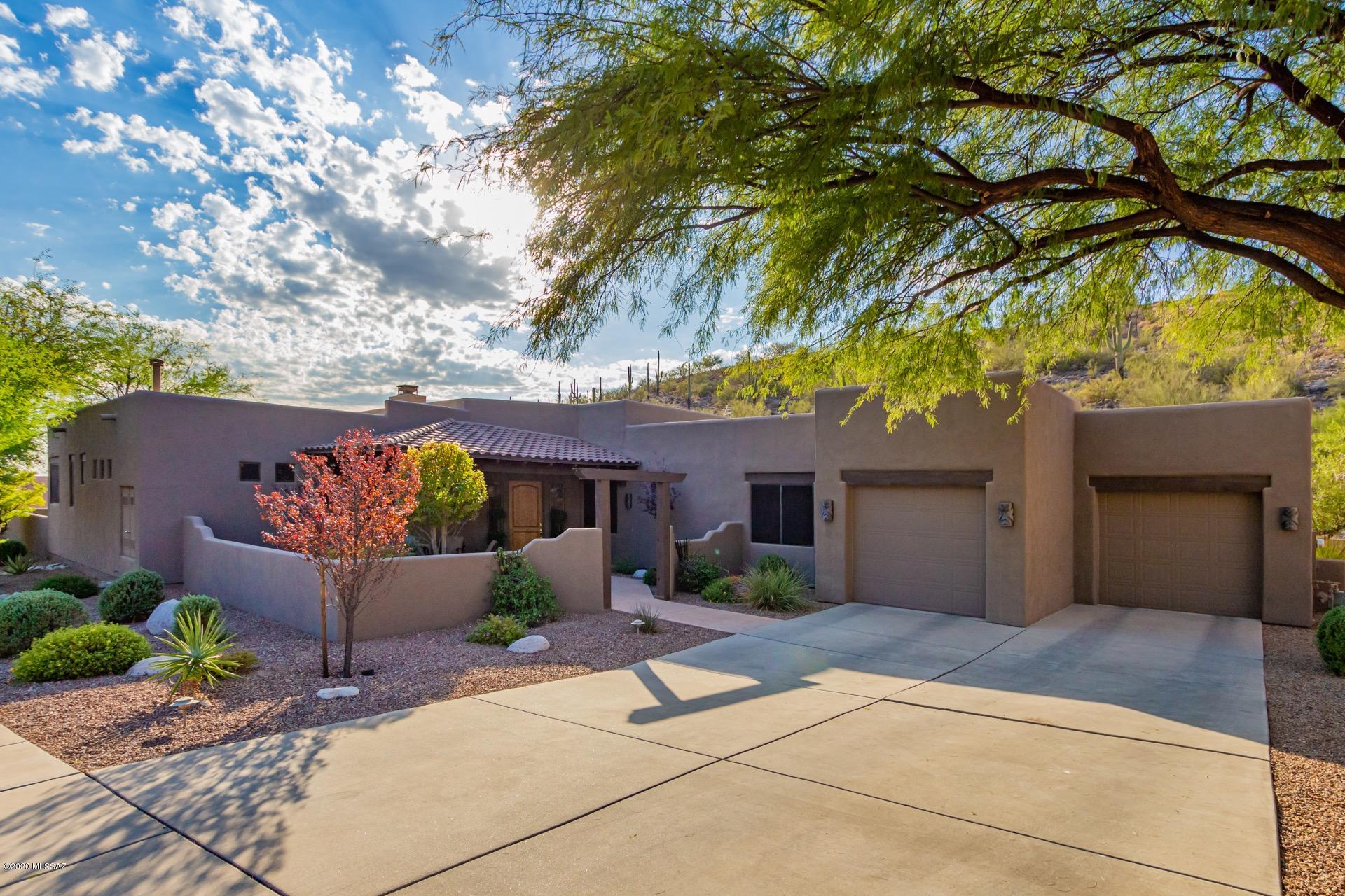 Welcome to this exquisite, contemporary, masterfully designed home, which backs to prestigious Sabino Mountain. Inviting landscaped private front courtyard,  enter through a dramatic 8' front door and walk into the spacious, beautifully designed great room and formal dining room, which adjoins a gourmet kitchen, granite counter tops and beautiful back splash. Includes an eat in kitchen area, walk in pantry, maple cabinets t/o! Ceramic tile in all the right places with neutral carpet in 4 bedrooms! This amazing home has so many upgrades & amenities, including an elegant crystal chandelier in the master bedroom sitting room.  All fixtures are top of the line including ceiling fans in 5 rooms. Fantastic surround sound system that  includes indoor and outdoor, making your experience magical! French doors exit from the great room and master bedroom to the back yard that will take your breath away! Featuring a huge, gorgeous salt water pool & spa, new 2017 pool heater, and pool filter & pumps. The natural gas spa sits separately near the outdoor fire pit with sparkling crystals also will help you relax and enjoy owning your own 1.59 acres that includes the mountain side, surrounded by Saguaro cactus and all the amazing cacti an plants that make this yard truly amazing!