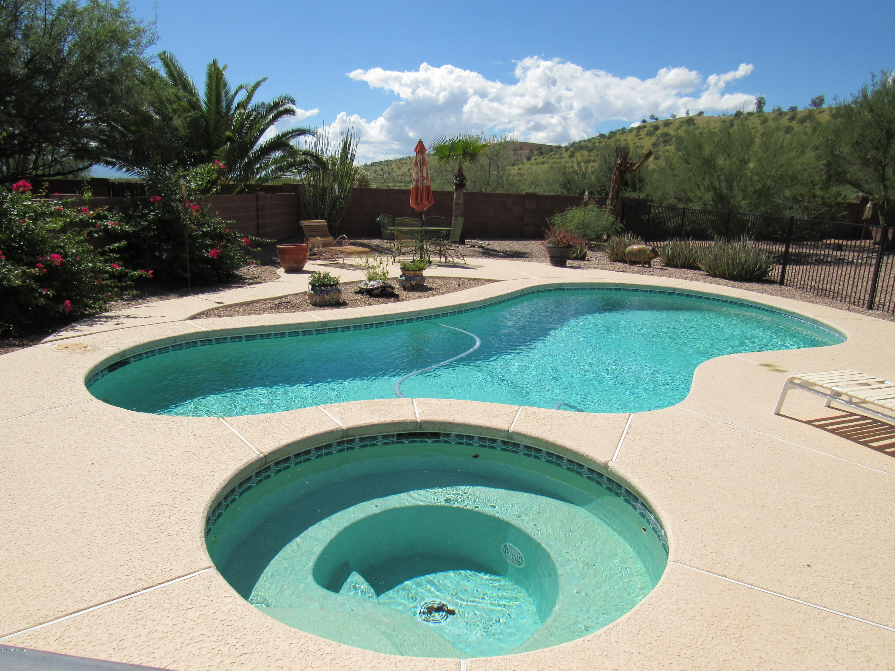 Beautiful 4 bedroom, 2 bath home, on over 1/3 of an acre, with a sparkling inground pool and spa, and no rear neighbors. With the 2.5 car garage, mountain views, two living spaces, and gorgeous landscaping, this home is move in ready and going to sell fast! Situated in an awesome neighborhood, has low HOA fees, on a private lot, and with the pride of ownership showing in the flowers, trees, pavers, and beauty. The 4th bedroom makes a great office, with its double doors and two entry points. The master has a large walk-in closet, separate garden tub and show, bay window and double doors. The kitchen has a large island, breakfast bar, nook, and is open to the family room. Close to shopping, schools, easy free-way access, and priced to sell!