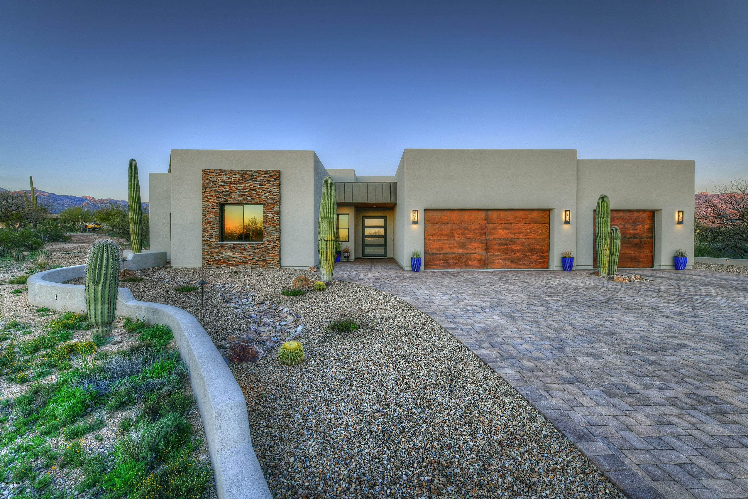 Stunning 4 bed/3.5 bath home nestled at the base of the Rincons in a gated community. Flawless floor plan boasts great room concept w/fireplace, 12 ft. glass slider door, formal dining w/hand hewn wood ceiling. Gourmet kitchen, double ovens, built-in  48'' refrigerator, center island & peninsula, Quartz site counters & custom cabinets.  Custom home theatre room w/built in bar/stacked stone columns, bar area seating. Luxurious Master Suite, split bedrooms, spacious 3rd & 4th bedrooms w/private baths. Solid knotty alder doors,  flawless paint/wood plank tile. Resort style backyard-breathtaking views, automated pool/spa w/solar heat & smart system, cantina w/BBQ & bar seating. Audio/video w/built in speakers inside & out, extended 3 car garage w/storage, paver drive, dual 16 seer A/C's, 1.7 a