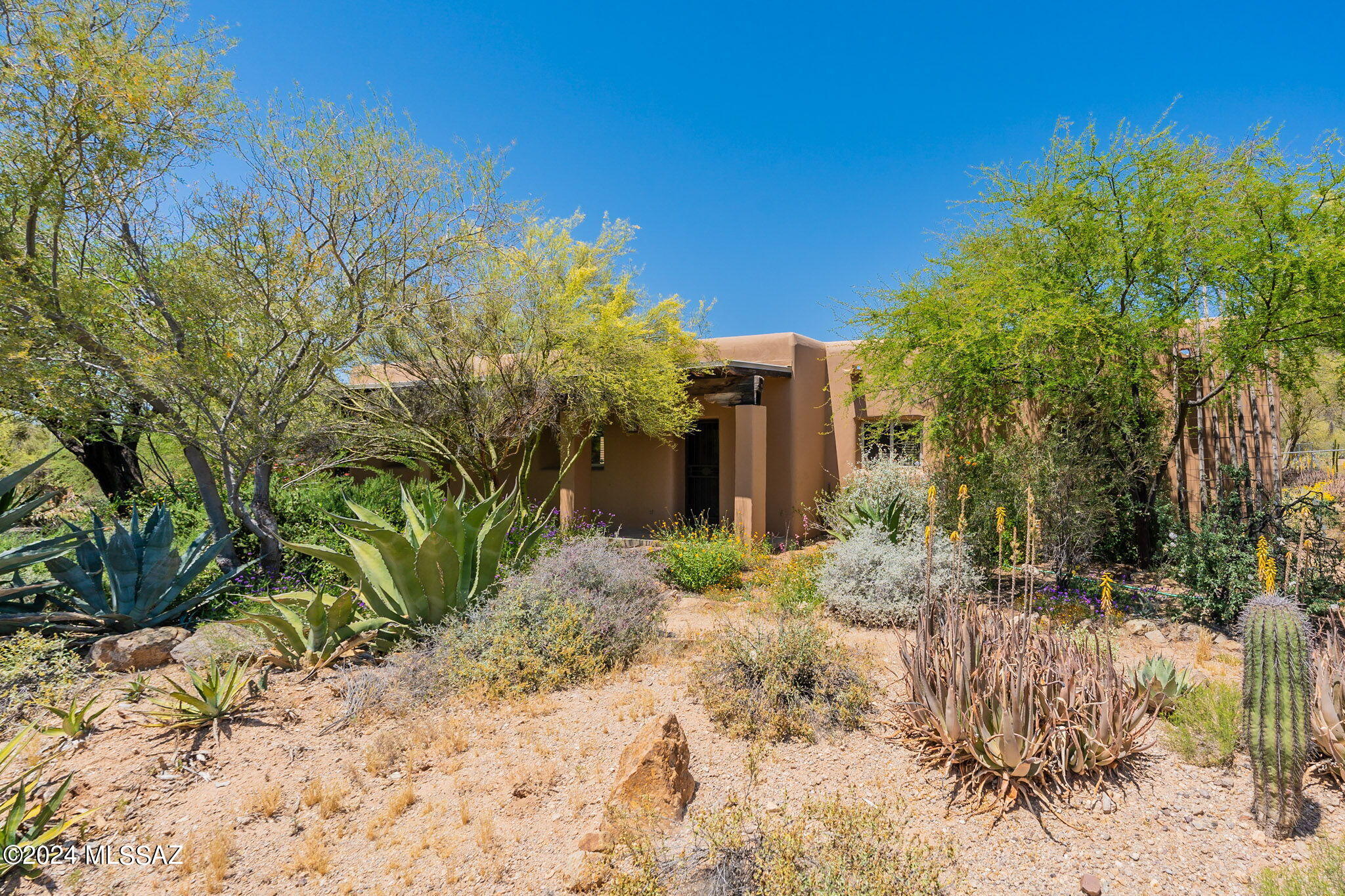 Exquisite custom Santa Fe style hacienda constructed of straw bale & rammed earth for thermal mass & timeless character. Old world artistry in 3 bed/2 bath main house w/hand cut corbels, beamed ceilings, flagstone floors & plaster finished walls. Open kitchen, cozy kiva fireplace, dual pane windows, patios & porches w/mountain views. Private straw bale guest studio w/kitchenette recently renovated & gorgeous! (See photos) Separate 3 car garage w/rusted metal door, workshop area, even bonus room w/mini split HVAC. Two septic systems, gated entry. Both dwellings conveying fully furnished is a negotiable option. Contact listing agent & see all attached Documents for further details.