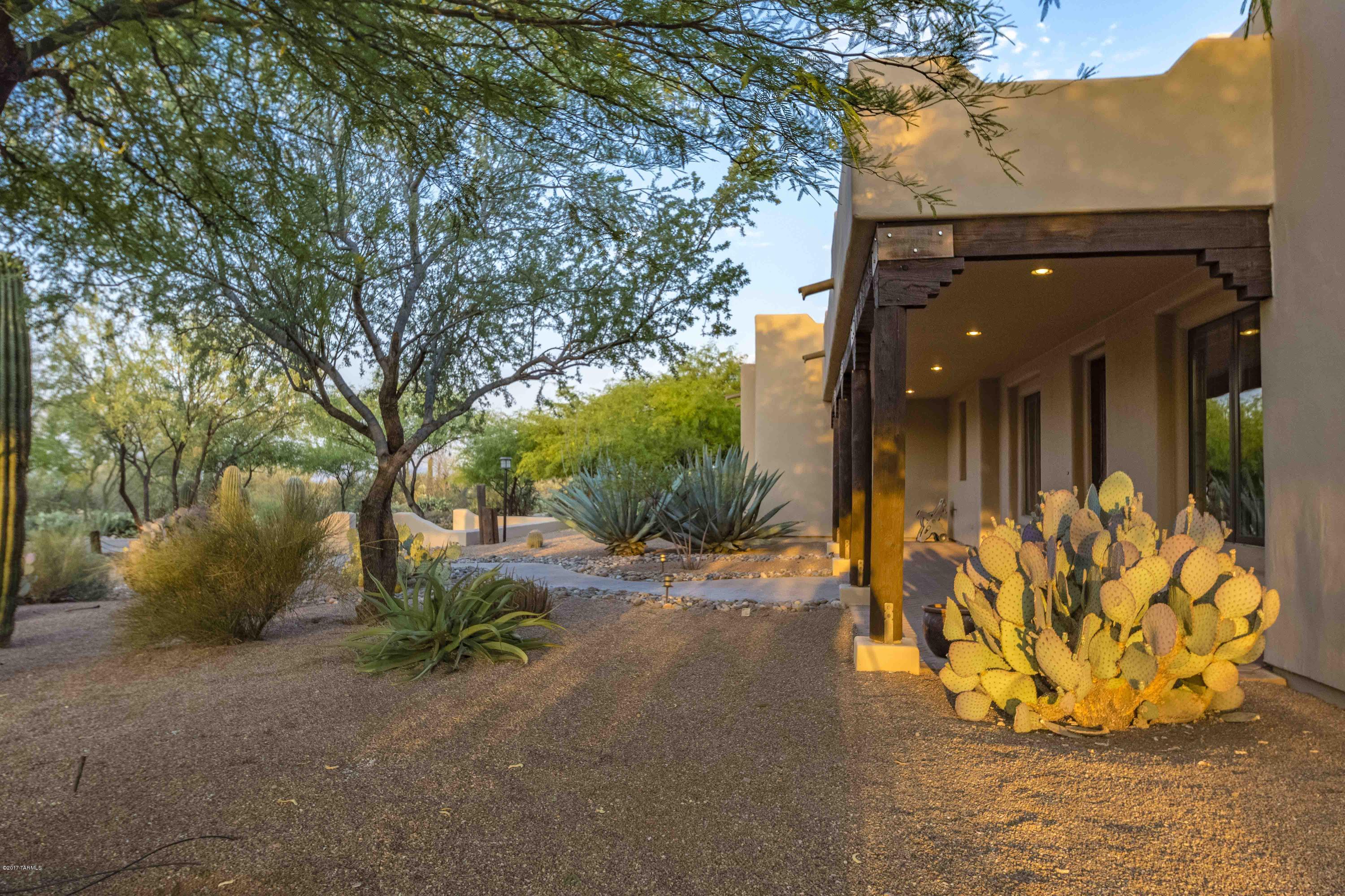 Private secluded Hacienda with a contemporary touch, nested in the heart of Oro Valley, brings to life the elegance and spirit of Classic Old Tucson with 5,274 sq ft of living/lifestyle space. Main house has 3451 sq ft, 3BR/4BA & office + 1823 sq ft 1BR/1BA Casita with media room, office & entertaining space. Over-sized 5 car garage w/epoxy floors for the car aficionado. Surrounded by lush mesquite trees and saguaros, the property features outdoor living area w/BBQ grill, gas fireplace & rooftop viewing area accessed via spiral staircase. Lovely gourmet kitchen features granite counter top, cherry cabinets & walk-in butler’s pantry. Concrete flooring, 8 ft. solid alder doors & Pella wood encased triple pane windows. Bedrooms feature private baths and patios. *Please see addition remarks. Rainwater collection system - 5,000 gal. underground storage tanks with pump connected to drip irrigation system - Less than 1 inch of rain required to fully recharge rainwater system.
-Three on-demand gas water heaters supply hot water to the house
-Tiered media room with 70 inch flat screen TV & surround sound system included
-Built-in 36 inch Twin Peaks gas grill with rotisserie and smoker
-Intercom system to connect guest house to main house
-Casita BR/BA/OFFICE are Wheel Chair Accessible.