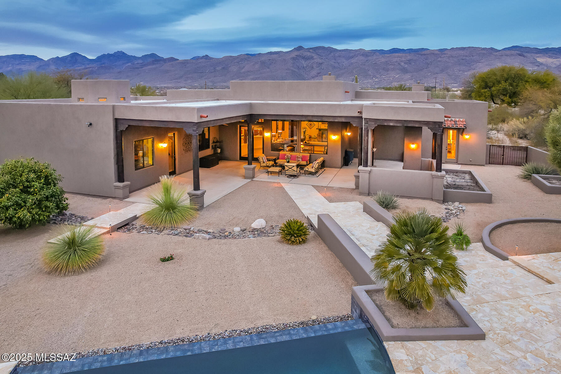 You will be in love the second you enter and look through to the alluring backyard w/gorgeous negative edge pool/spa/fireplace, Dominican tile (coral)decking & views. 12' ceilings for that airy & spacious, yet warm feel. Dual sided fireplace in great room/den. Space for everyone and everything. Split floorplan w/separate bedroom wings and extra rooms for office, library, den, whatever your needs are, they can be met with this home. If you love to cook this is the kitchen for you, island w/prep sink, gas cooktop, granite ctrs, amazing amount of cabinets & large pantry. Sumptuous primary w/fireplace, spa bath with jetted tub, large walk in shower, double vanity w/separate sit down vanity. See addl remarks: Other wing w/4 bedrooms, 2 full baths, study area & office.

4 Car garage w/epoxy floor, tons of room for work benches, exercise, multiple cars. Home has in ceiling sprinkler system. Large covered patio w/area already designated for outdoor kitchen (gas installed, power, in). Bring your excitement-this home is ready for it's new owner.