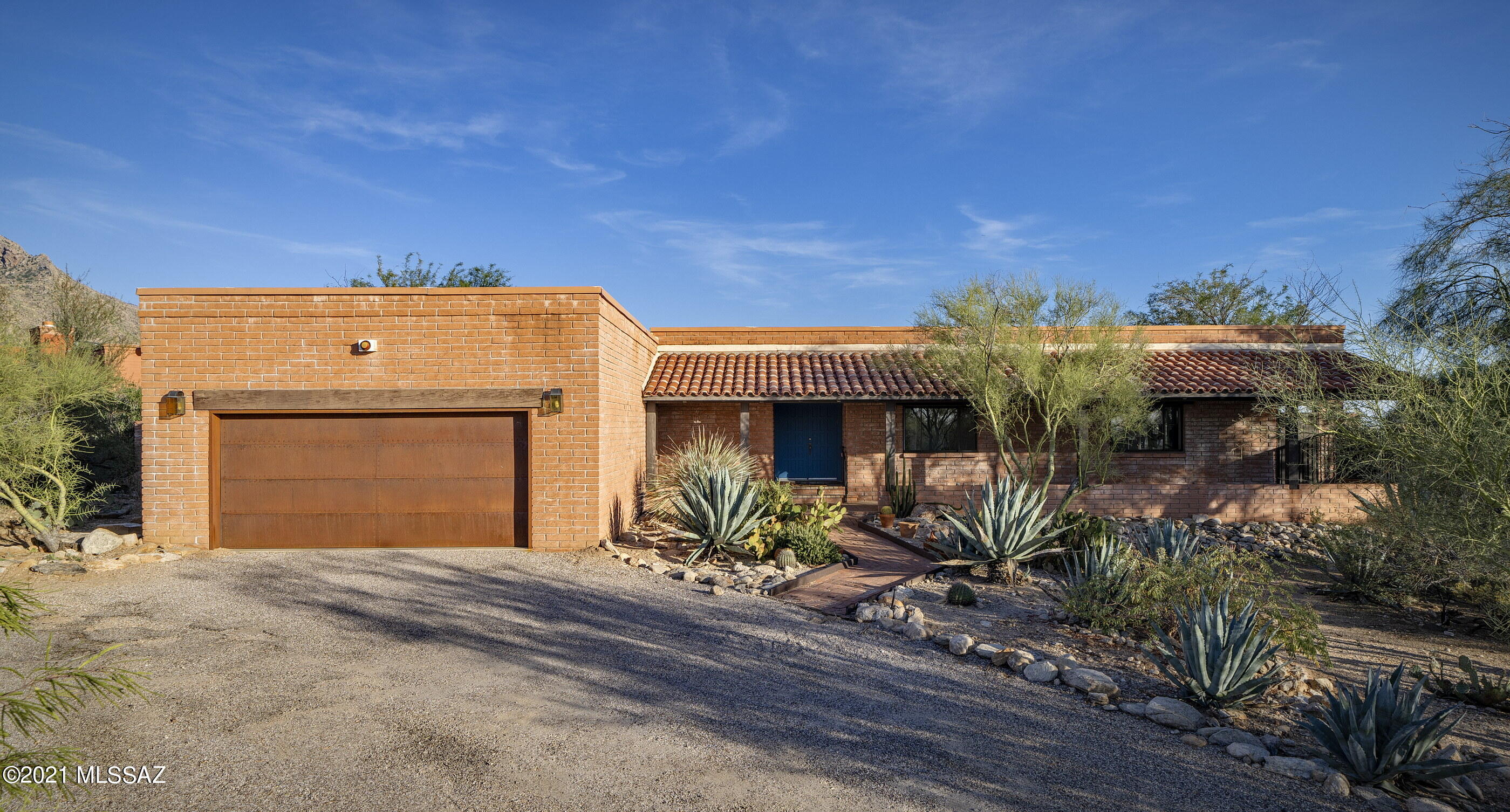 Sellers shall entertain offers between $750,000 - $775,000. Panoramic views of mountains, city, sunrise, and sunset set on a secluded lot just north of La Encantada Shopping Center in highly desirable ''Foothills''.  Luxuriously remodeled ranch style home with a mid-century vibe.  Open, light and bright with a huge expanse of windows to let the outside in.  A dream kitchen includes high-end granite, white newer cabinets, Samsung & Bosch appliances, & tons of storage.  Custom finishes throughout.  Brick wall fireplace. Newer lighting fixtures, ceiling fans, and bamboo flooring. A beautiful mix of Classic & Contemporary. Covered back patio faces East w/million dollar views.   Circle drive.  Low care desert front and back yards.  Room for a pool on north side.  Storage !