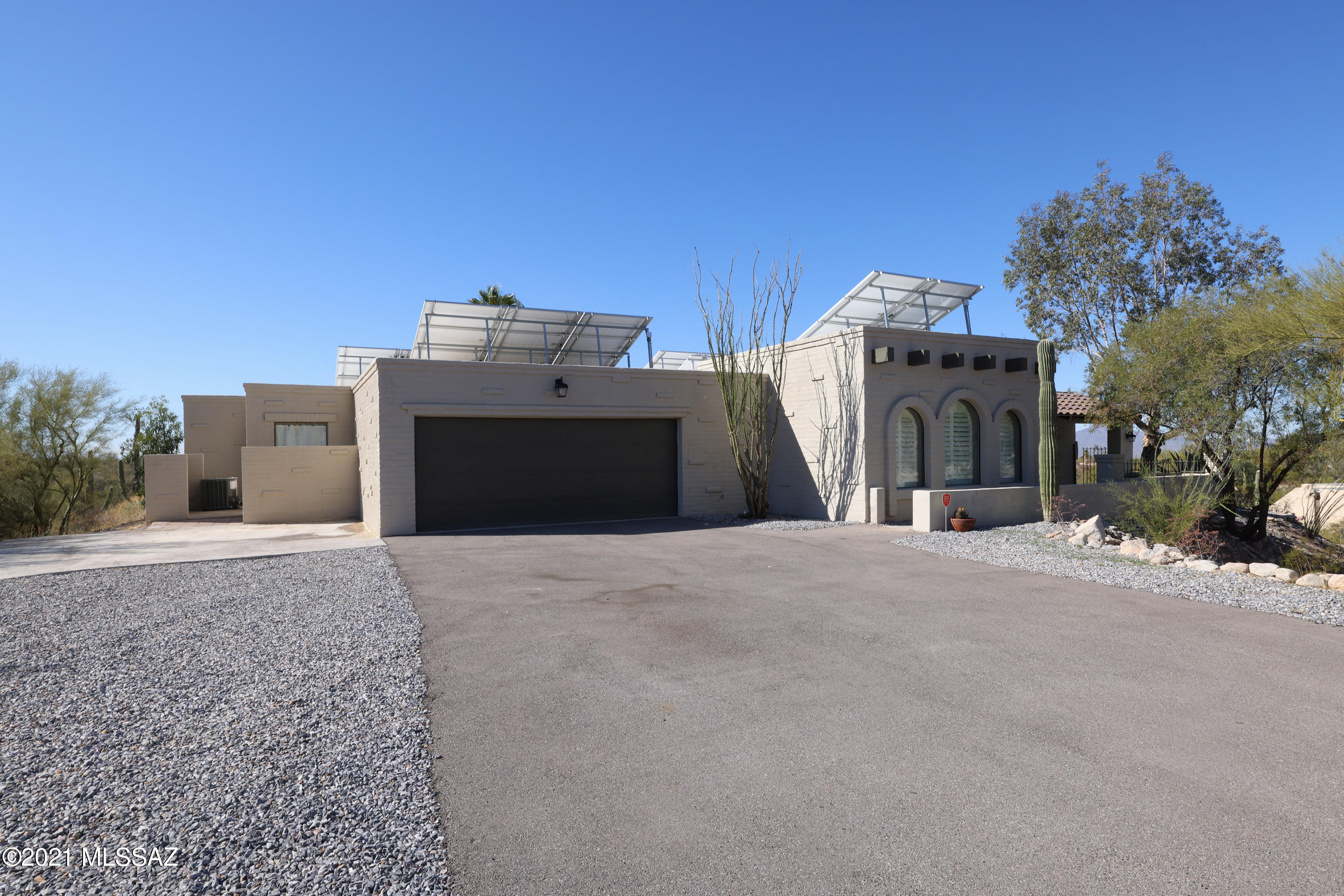 This recently updated foothills home on 1.22 acres offers any amenity a scrupulous buyer could want. Every window in the home boasts either mountain or city views. Convenient shopping and dining at La Encantada is within walking distance. The 2019 modern-style remodel includes a new driveway with plenty of parking space, two new HVAC units, updated kitchen with calacatta counters, large laundry room addition, new interior and exterior paint, and much more. The spa-like master bathroom contains dual floating vanities, a sunken tub with a view and an additional walk-in rain shower. You will not want to miss the sweeping valley view from the backyard pool area at this hilltop home. The solar panels are owned and yield a shockingly low monthly electric bill.
