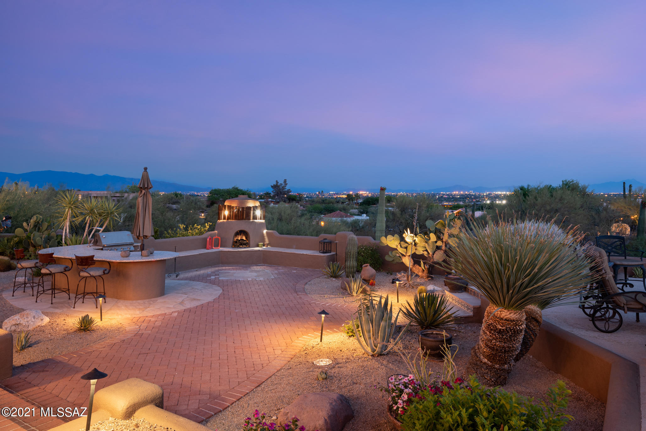 Exceptional Santa Fe on a 1.5 acre elevated, cul-de-sac lot w/ magnificent city views located in highly desirable, guard-gated Cat #10. Enter through a walled & gated courtyard anchored w/ a gorgeous fountain & mountain views.  Custom metal front doors lead to living rm/dining rm w/high beamed ceilings, fireplace & wall of windows to capture dramatic city views. Split bdrm floor plan offers 5 bdrms plus office/den & bonus room & 5 1/2 bathrooms w/ plenty of flexible space for entertaining. Spacious owner's suite  w/ huge master bath w/ 2 walk-in closets, sitting area, separate office/sun room, jetted tub & separate shower. Current owners opened kitchen to family room & renovated/remodeled w/ custom cabinets, granite & top of line appliances. Large windows flood the rooms w/  natural light Flexible space currently used for game room/ pool table. Travertine floors throughout the home.  Big backyard fully designed & landscaped w/ outdoor kitchen, fireplace & negative edge pool. Deep covered patio facilitates indoor/outdoor entertaining & living. The views are truly sensational. Short walk to the little chapel on the south end of this large lot w/north-south exposure.  Beautiful circular driveway & 3- car garage w/built-in storage cabinets.